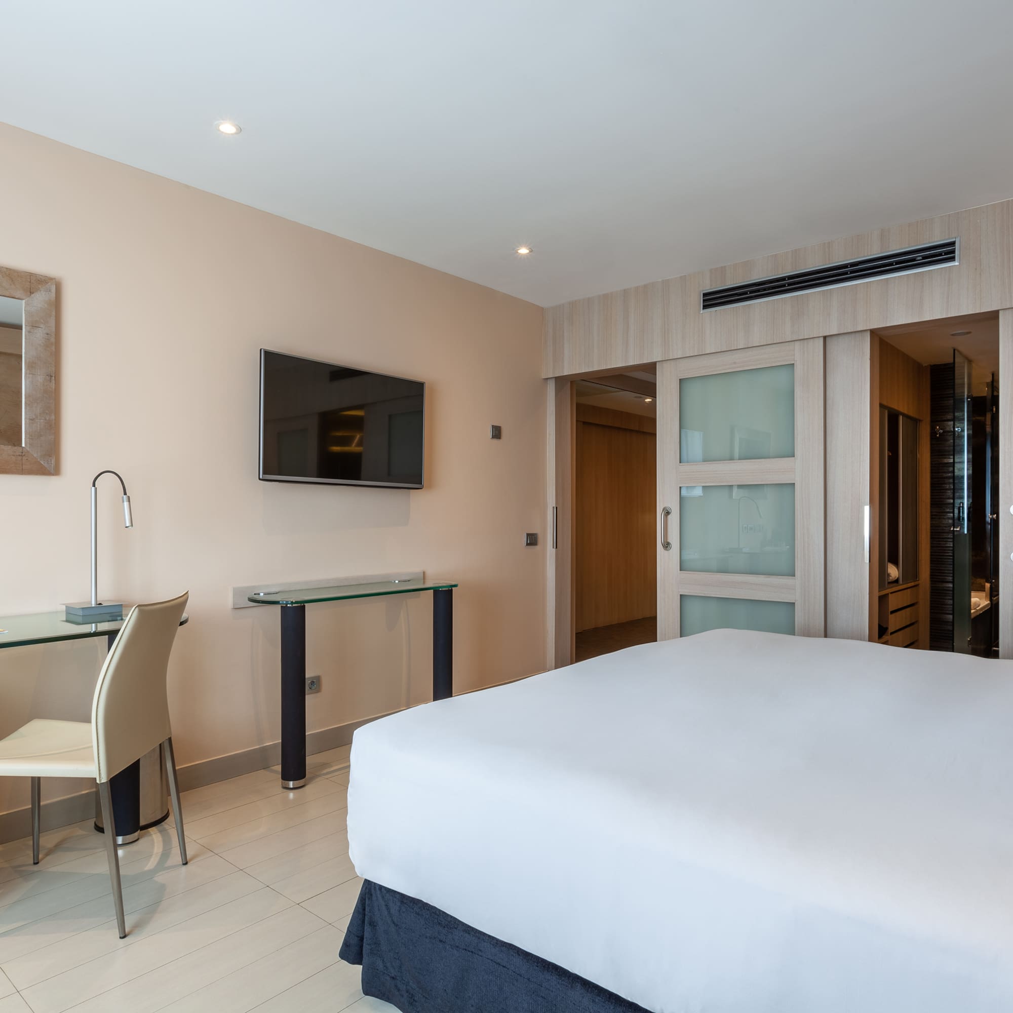 a bedroom with a bed and a desk