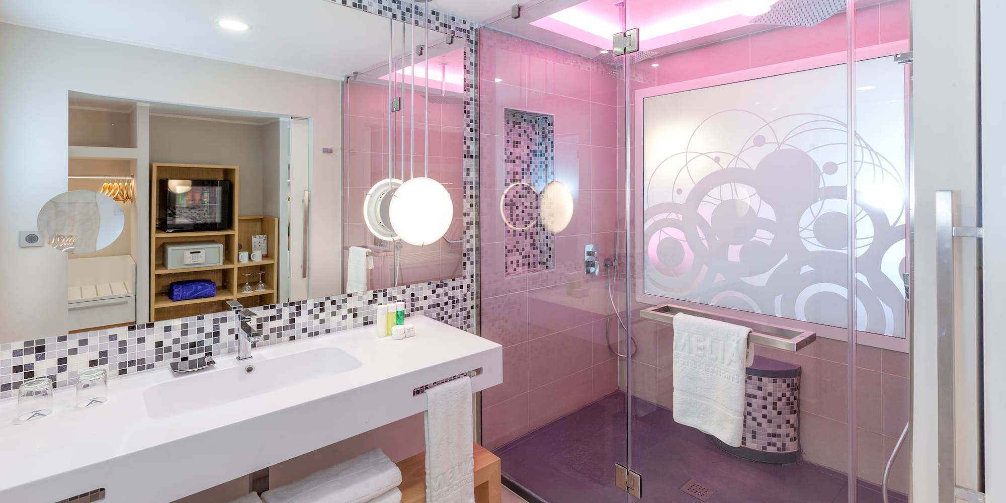 a bathroom with a glass shower and sink