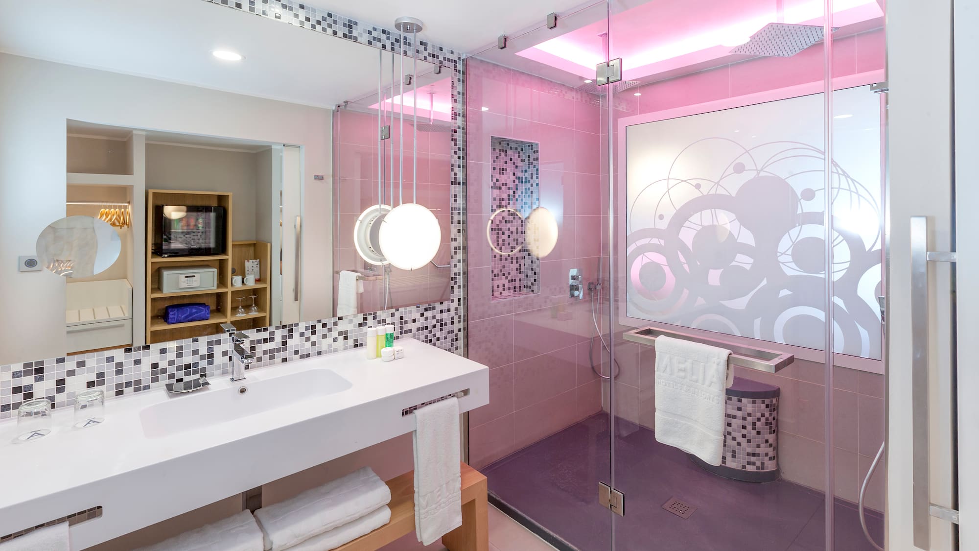 a bathroom with a glass shower and sink