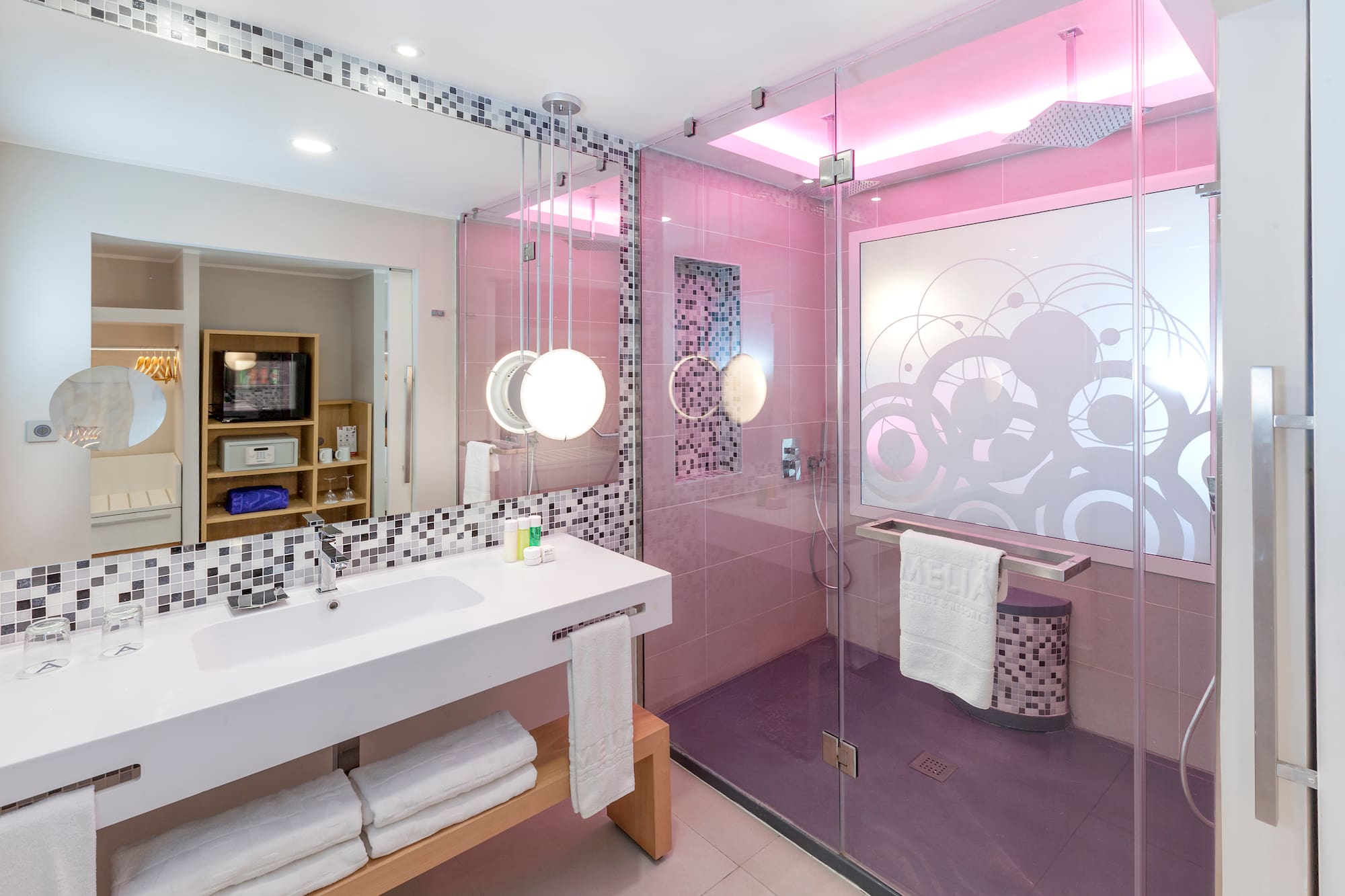 a bathroom with a glass shower and sink