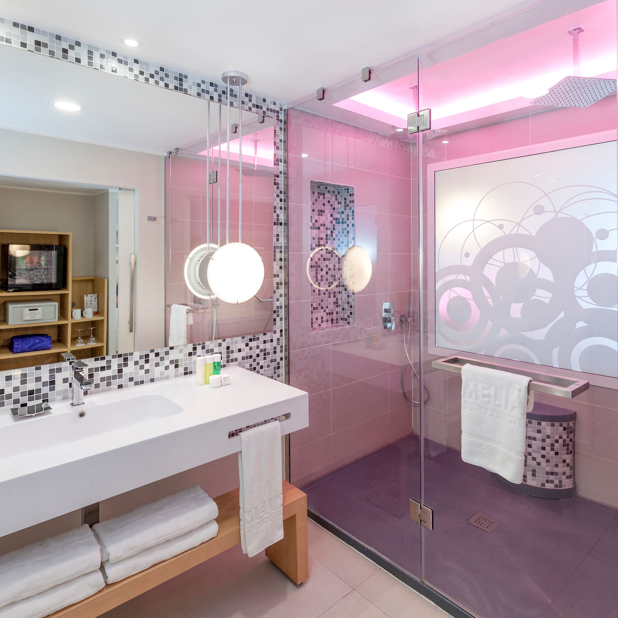 a bathroom with a glass shower and sink