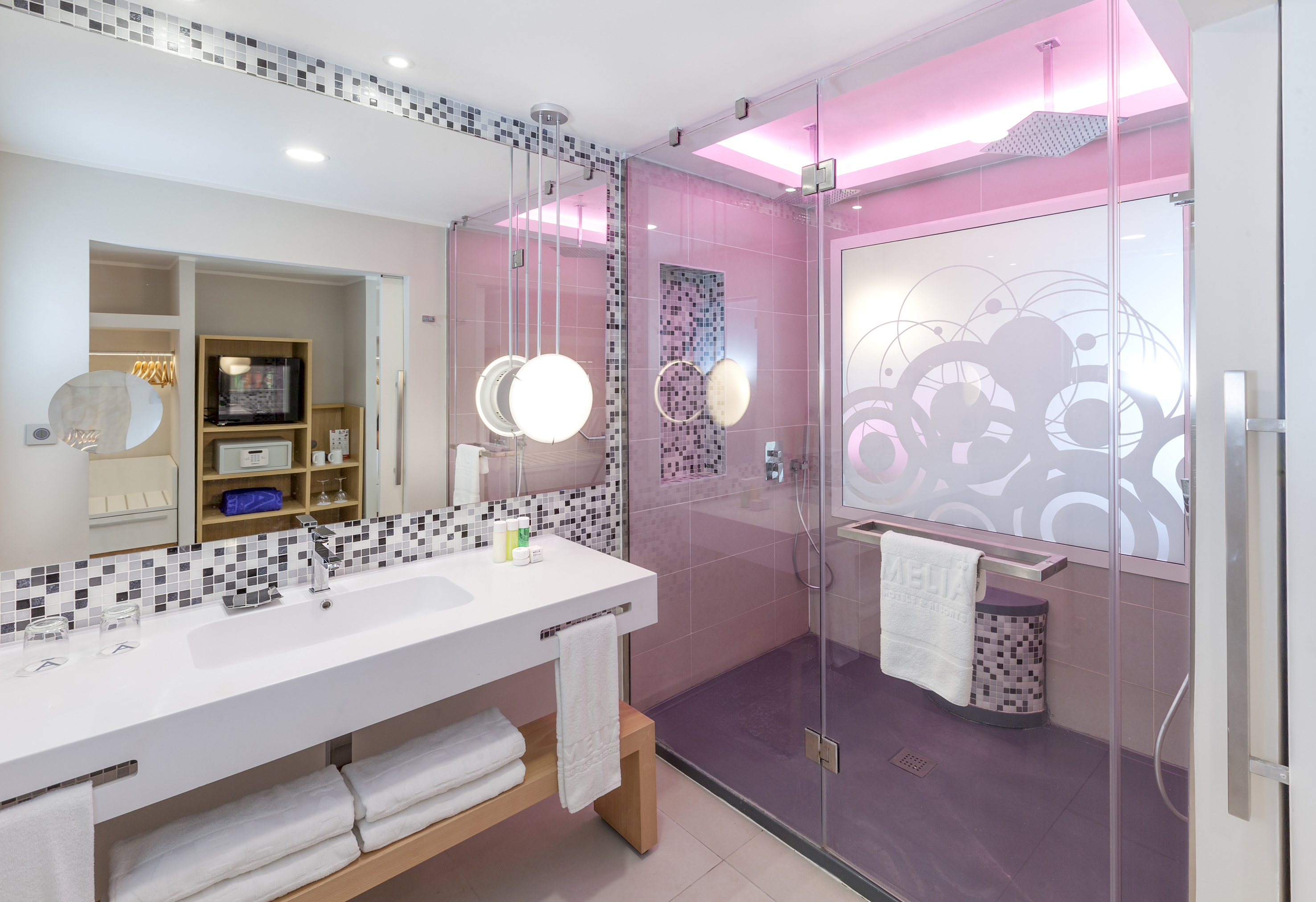 a bathroom with a glass shower and sink