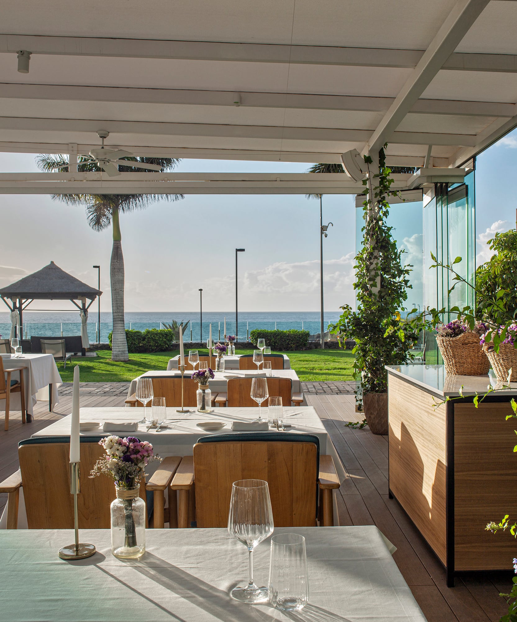 a restaurant with tables and chairs and plants