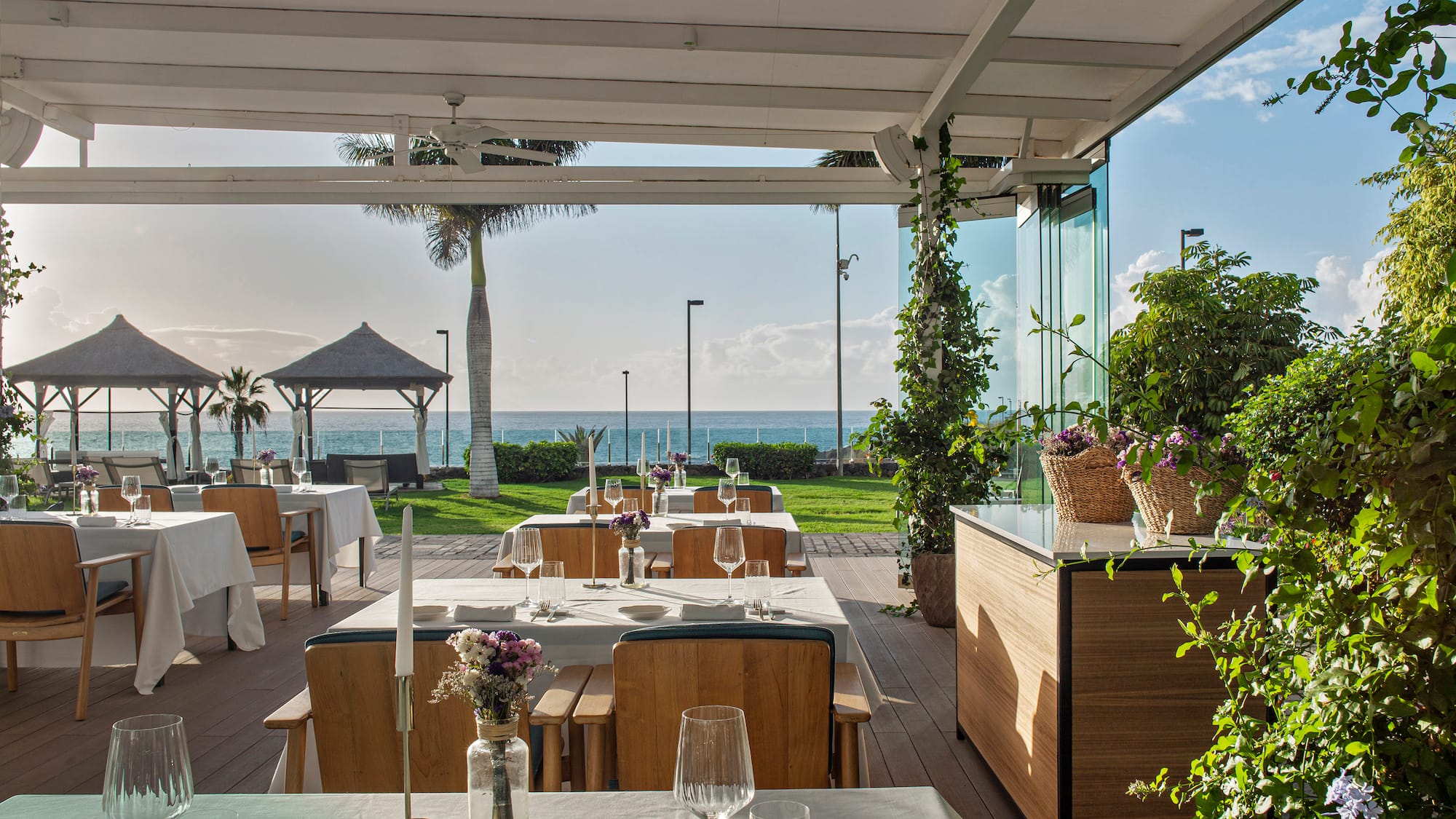a restaurant with tables and chairs and plants