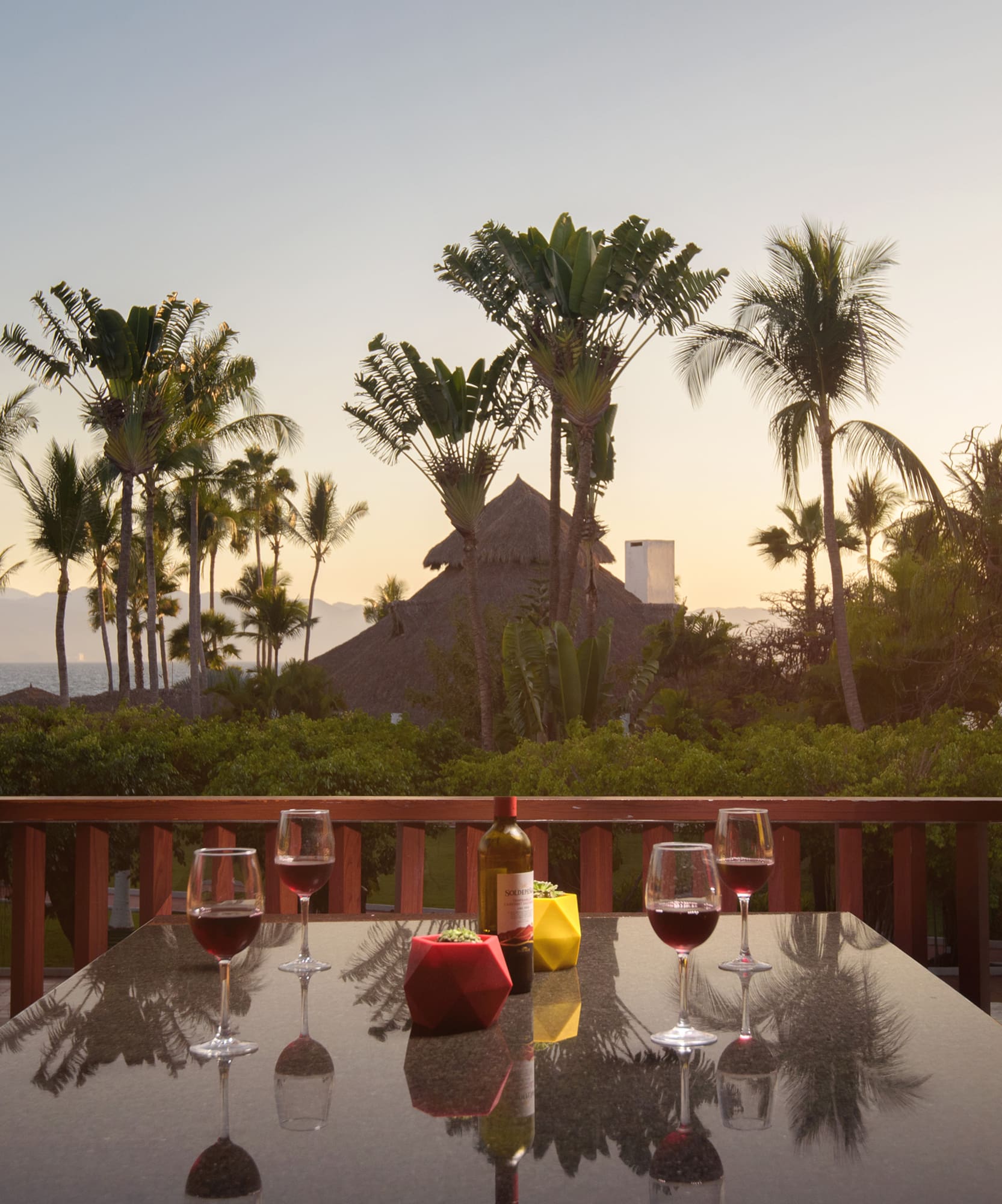 a table with wine glasses and bottles on it