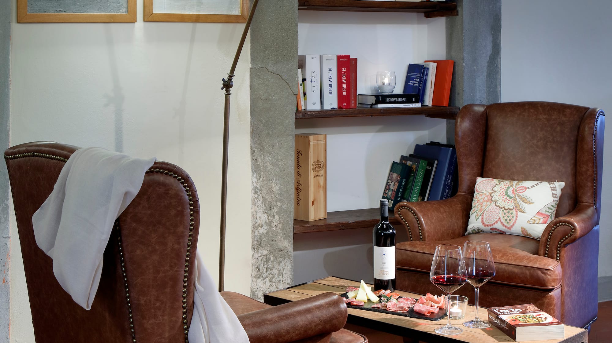 a room with leather chairs and a table with wine