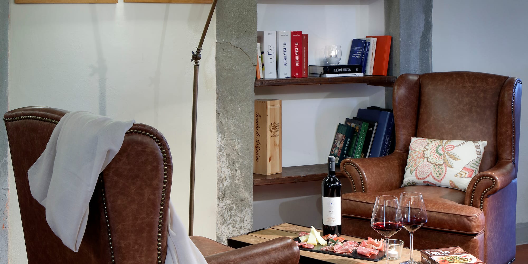 a room with leather chairs and a table with wine