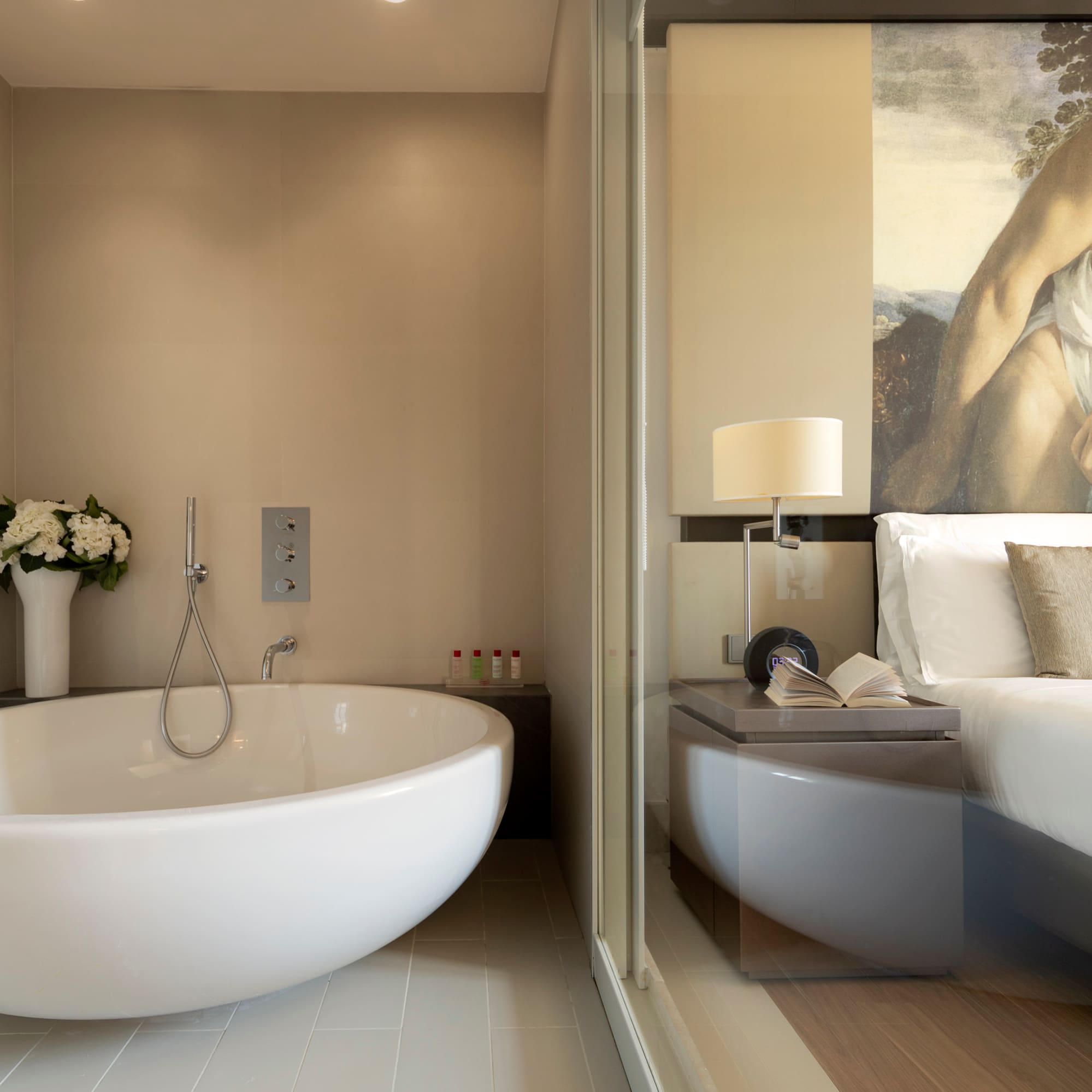 a bathroom with a bathtub and a bed