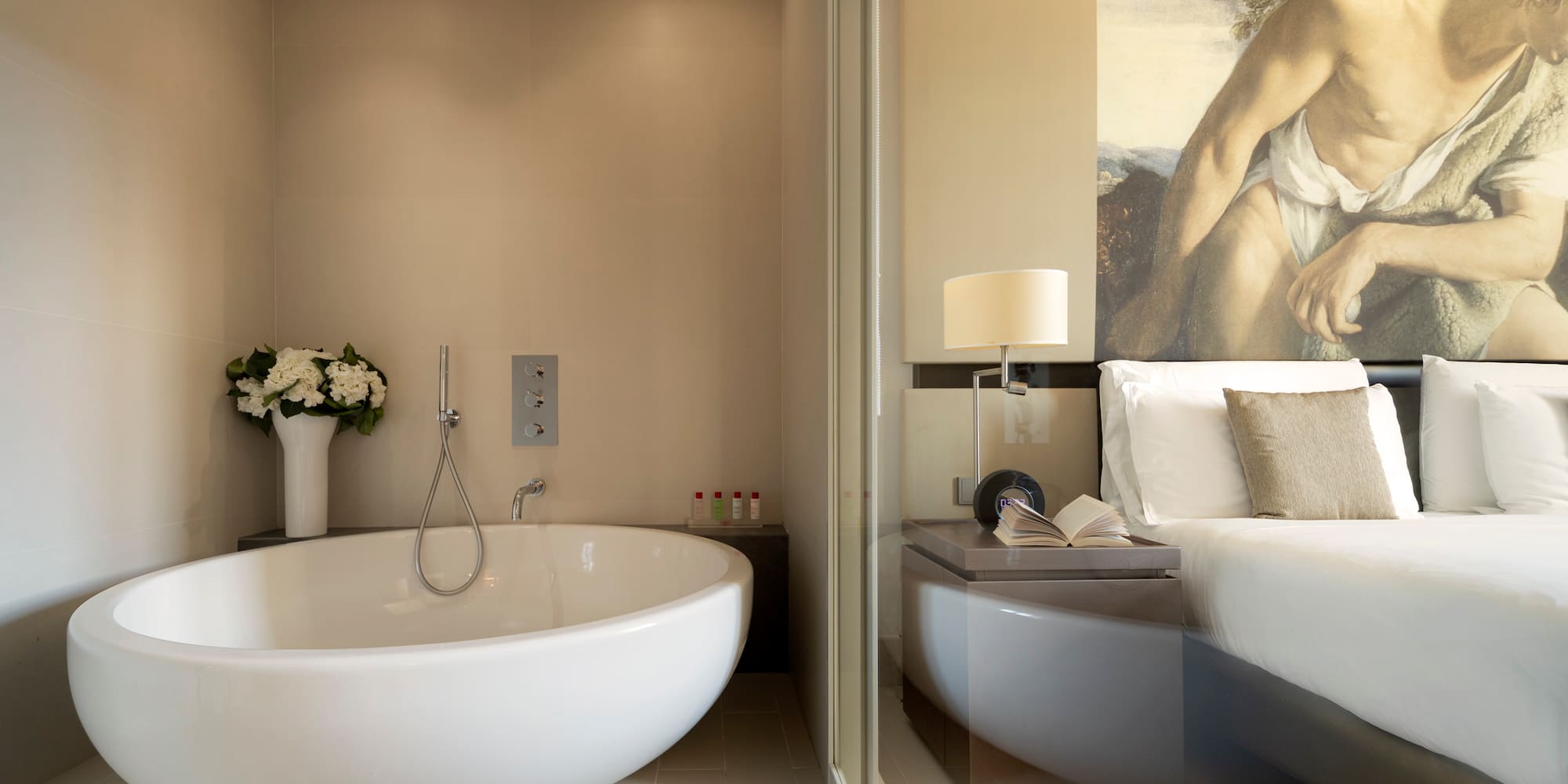 a bathroom with a bathtub and a bed