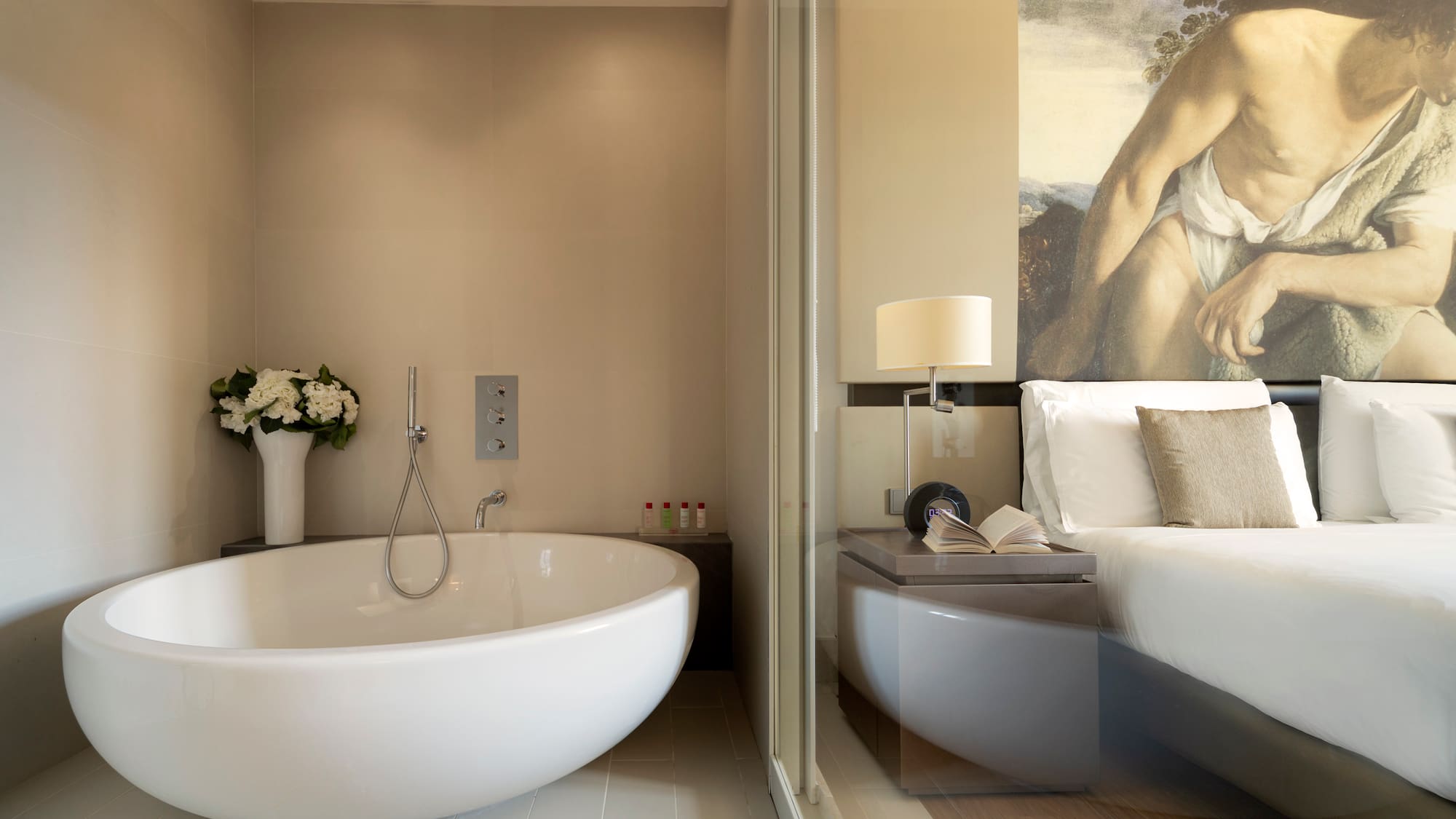 a bathroom with a bathtub and a bed