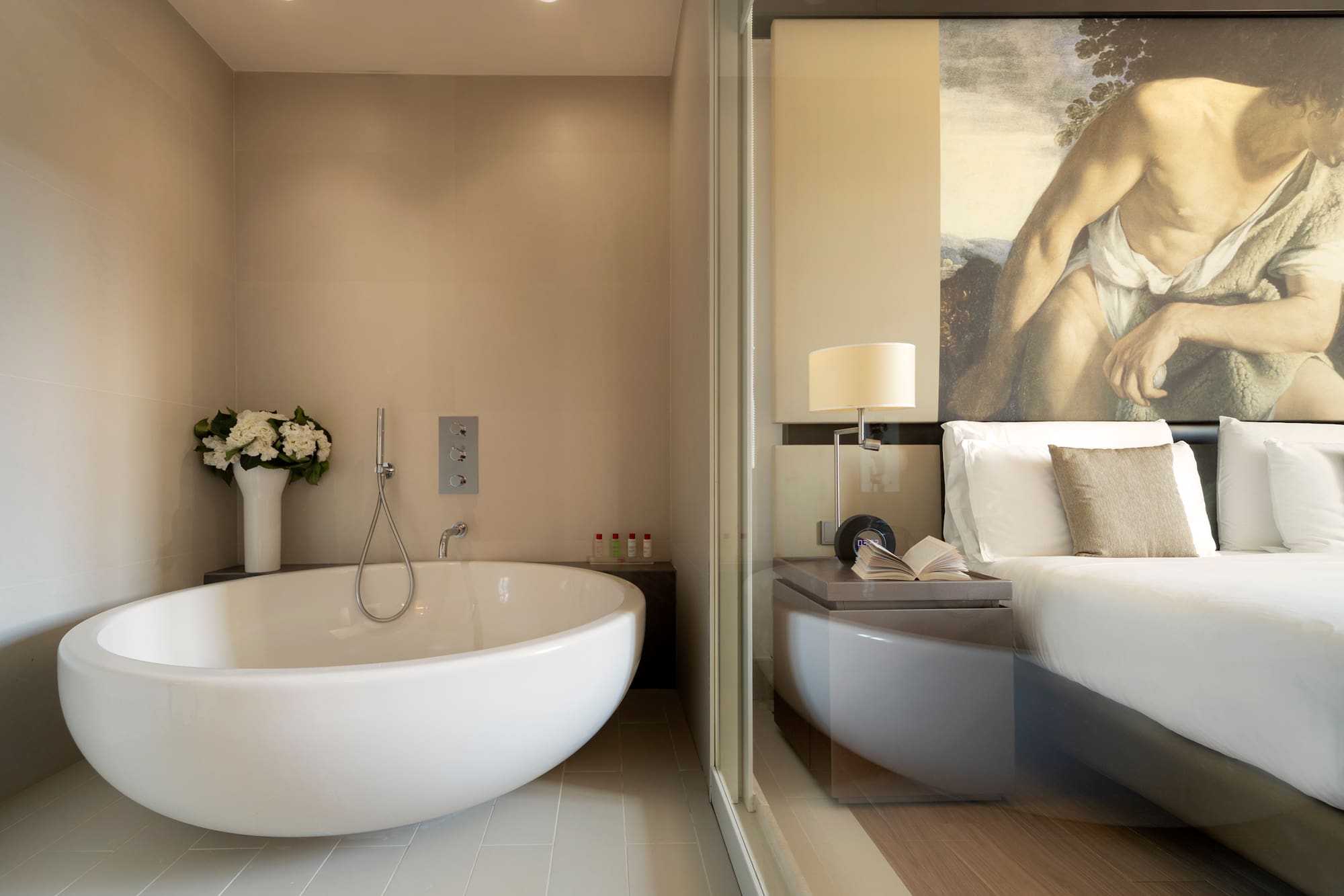 a bathroom with a bathtub and a bed