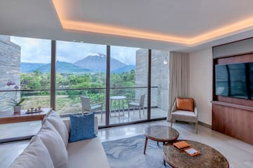 a living room with a view of mountains and trees