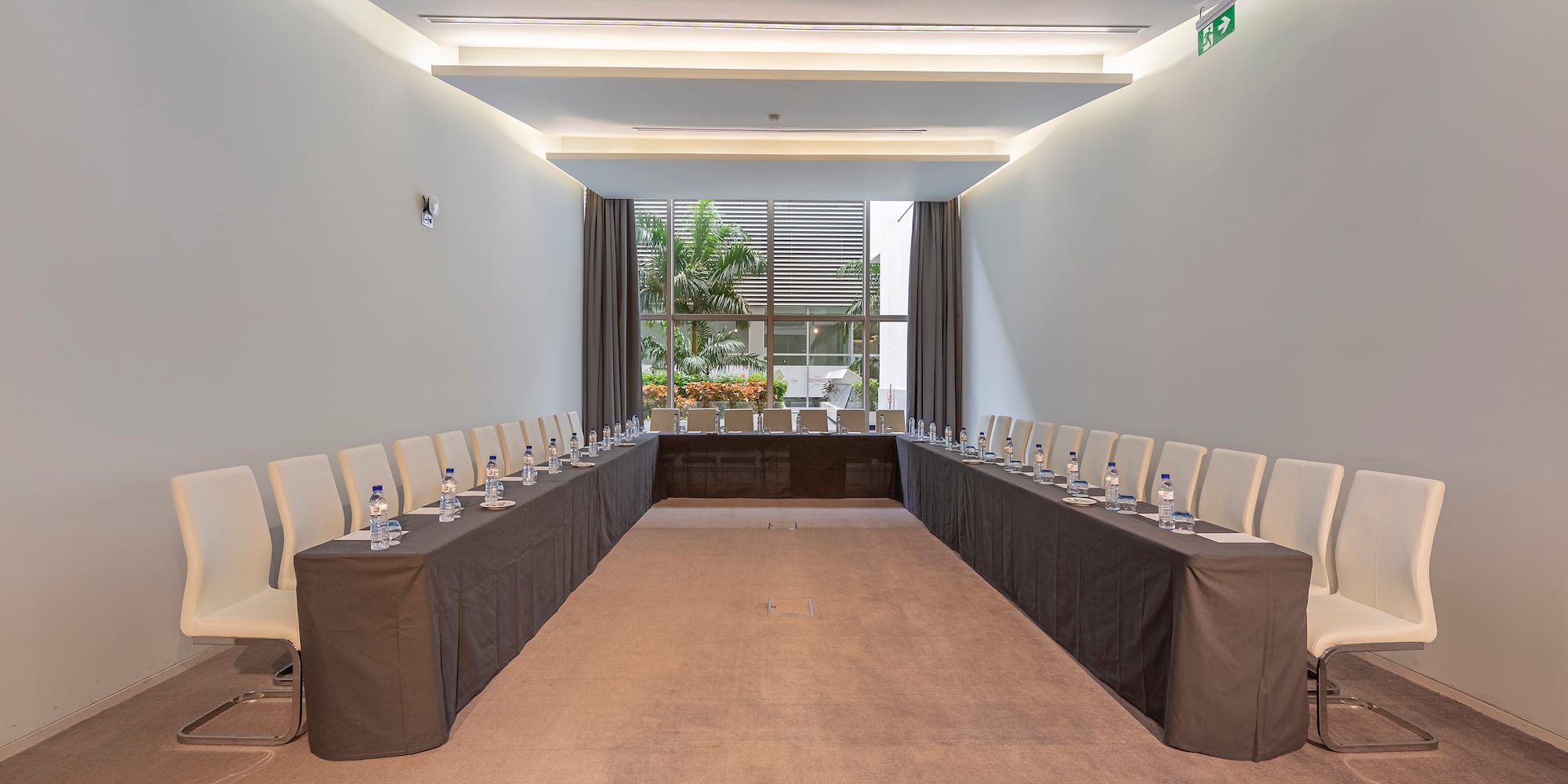 a room with long tables and chairs