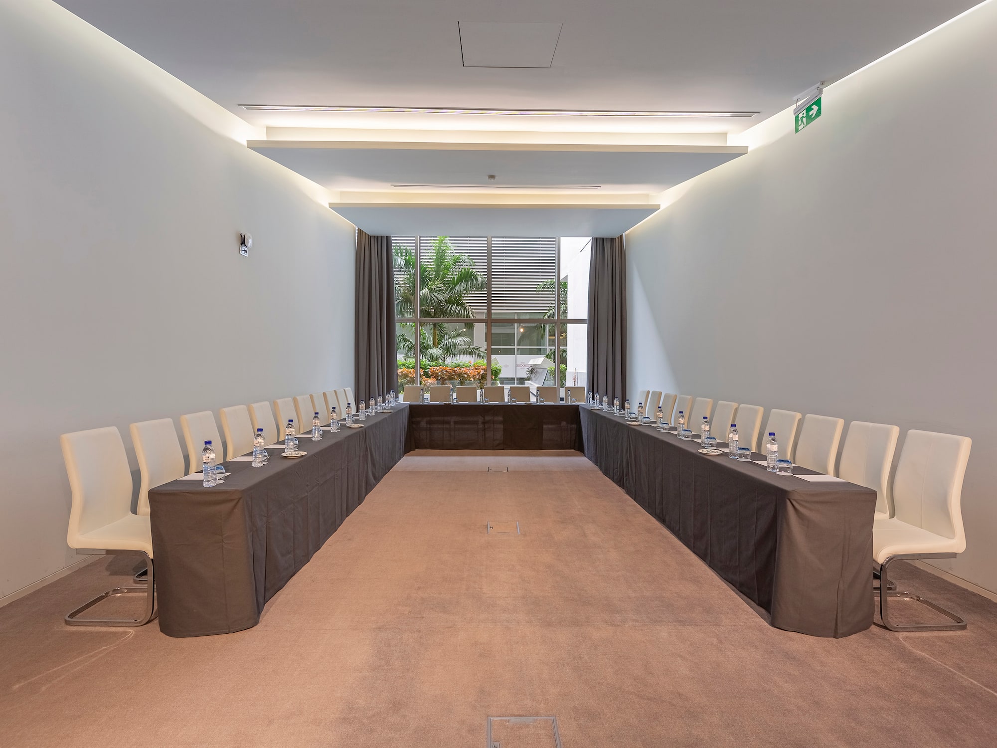 a room with long tables and chairs
