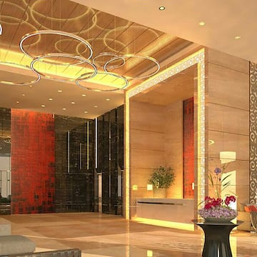 a lobby with a large reception desk and a large mirror