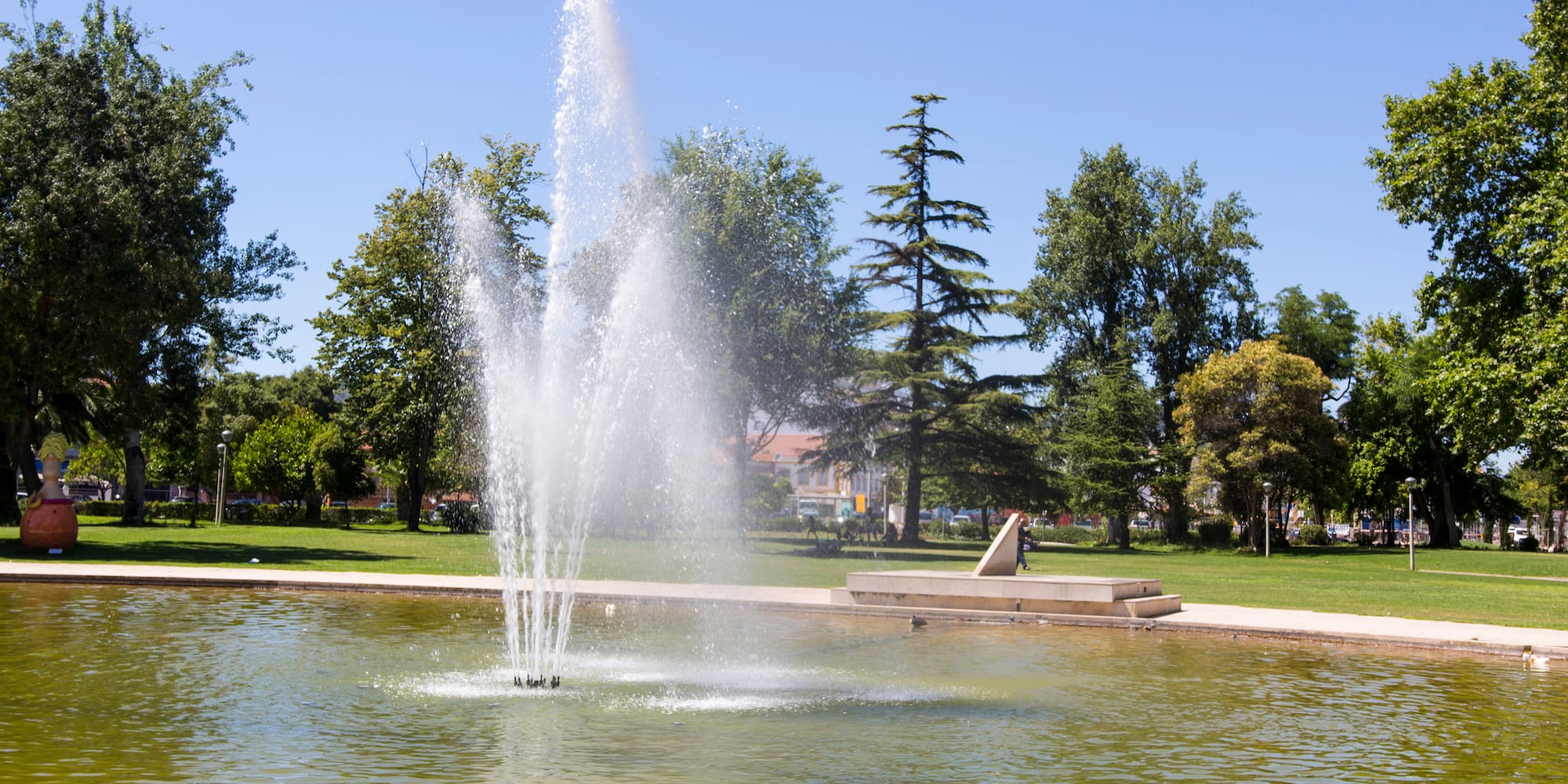a water fountain in a pond