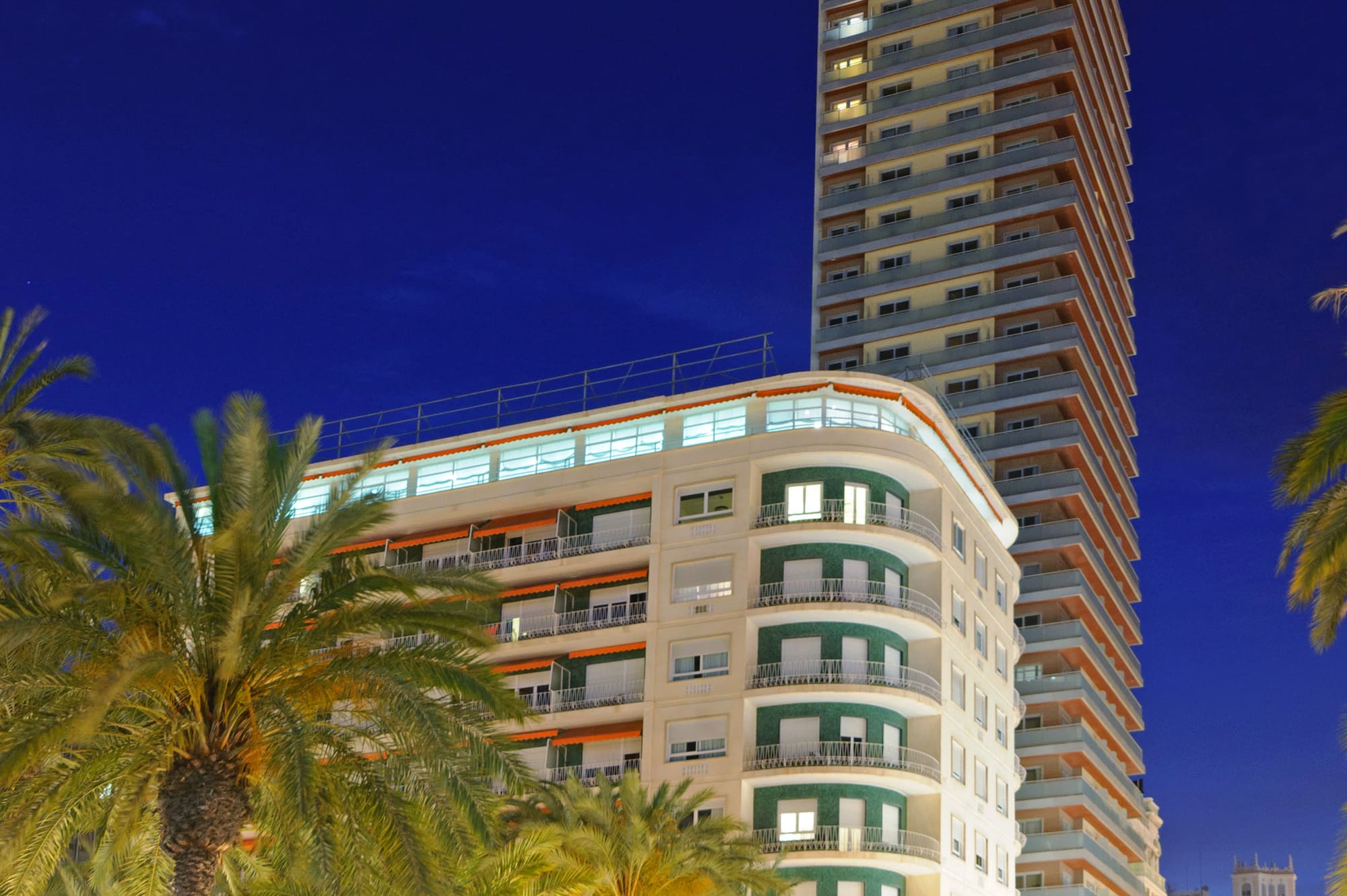 a tall building with palm trees