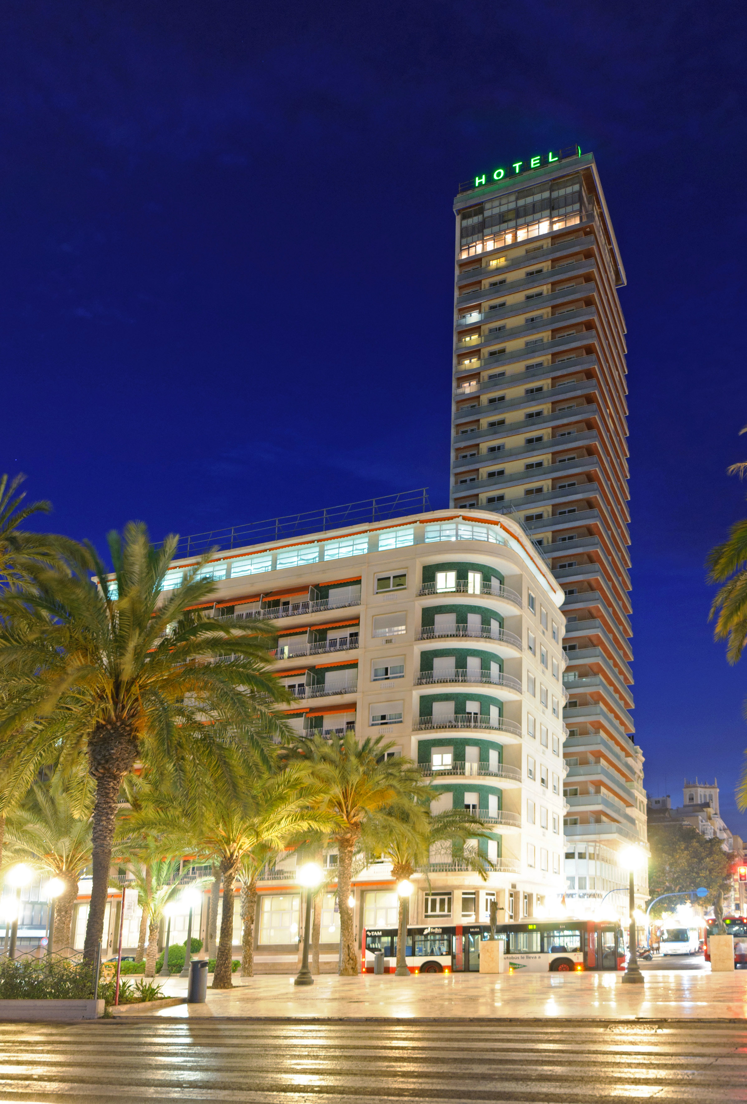 a tall building with palm trees