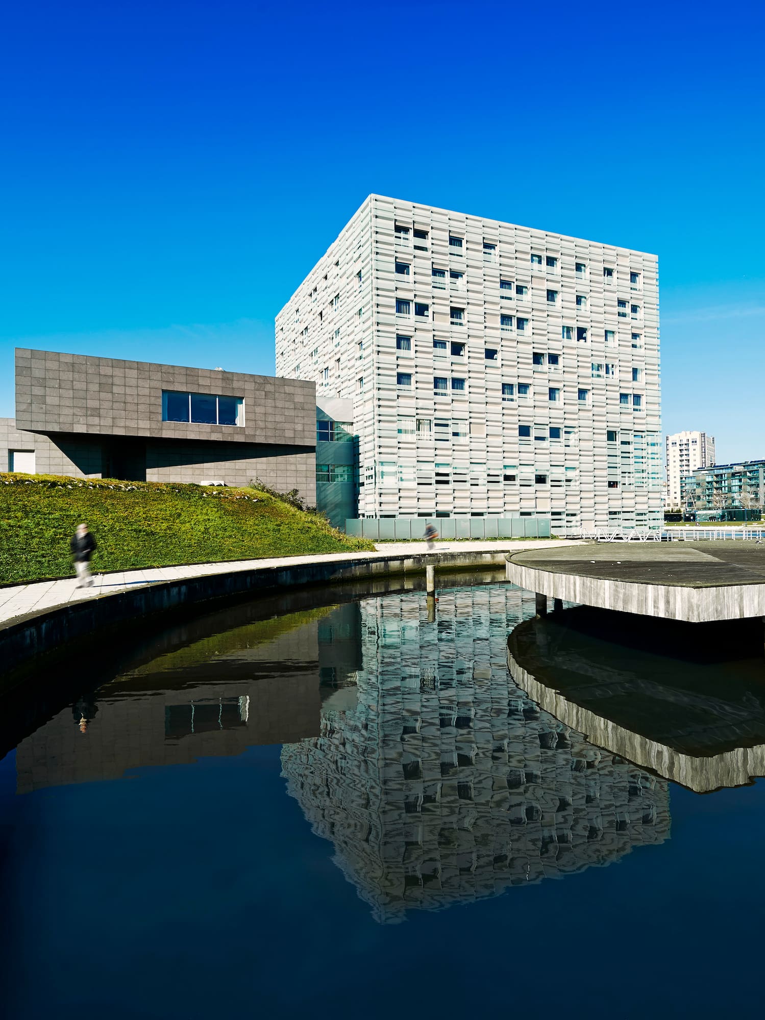 a building next to a pond