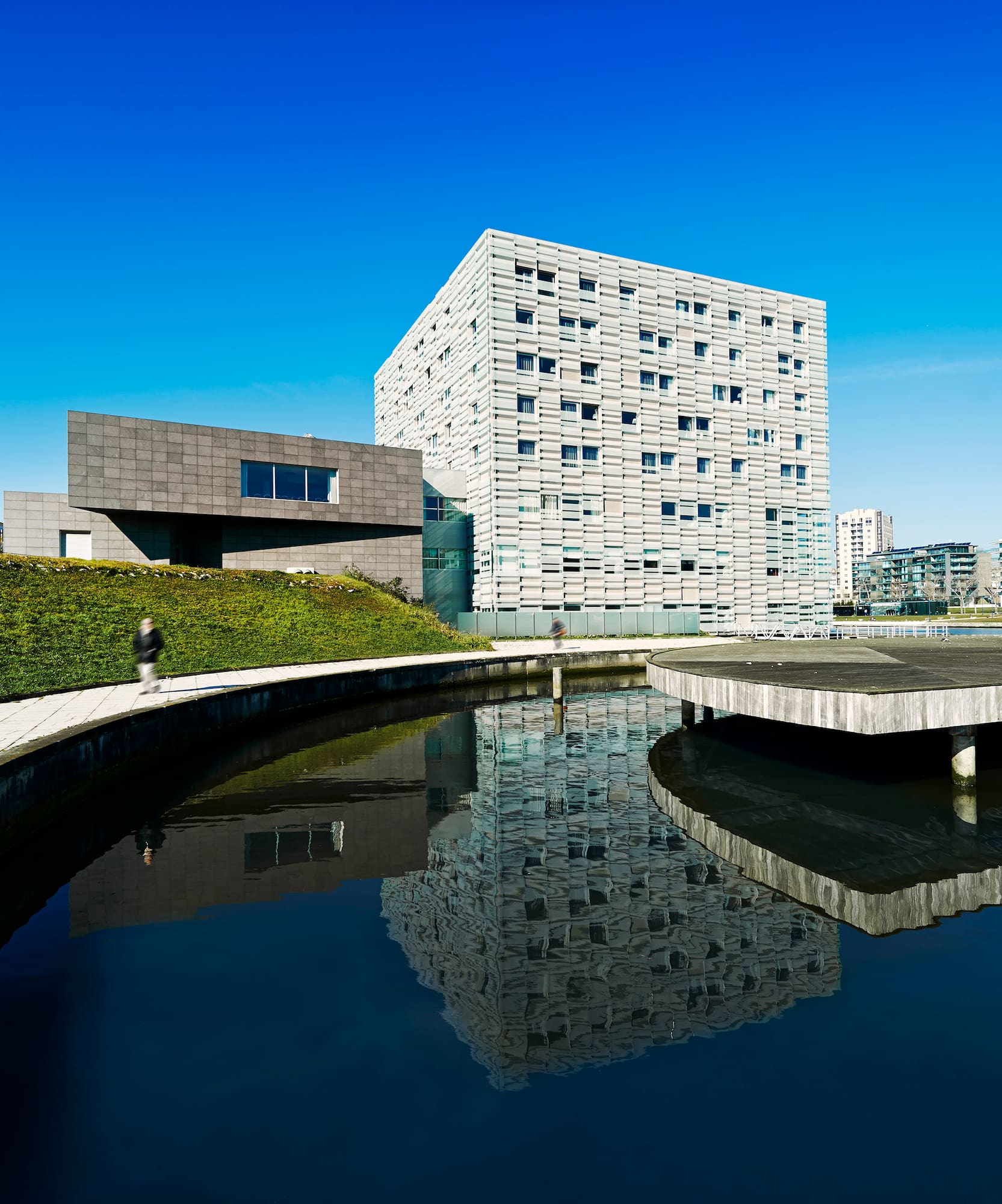 a building next to a pond