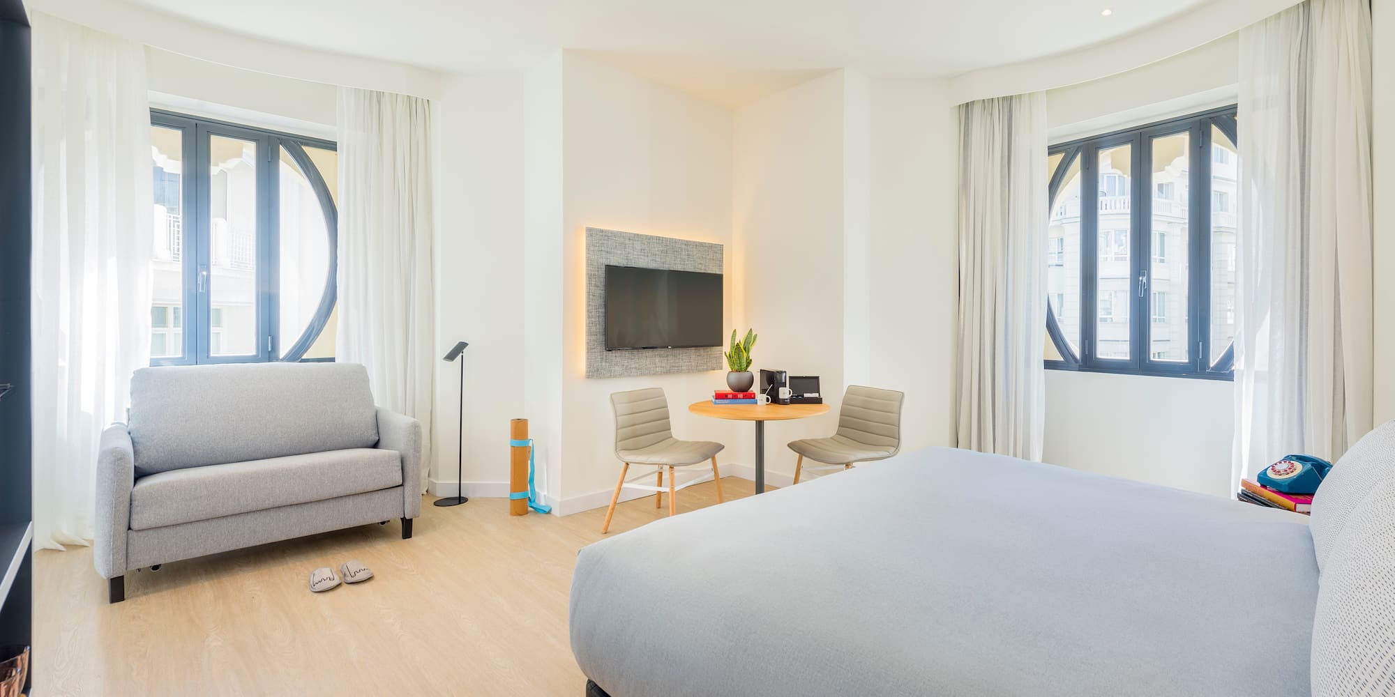 a bedroom with a bed and a tv