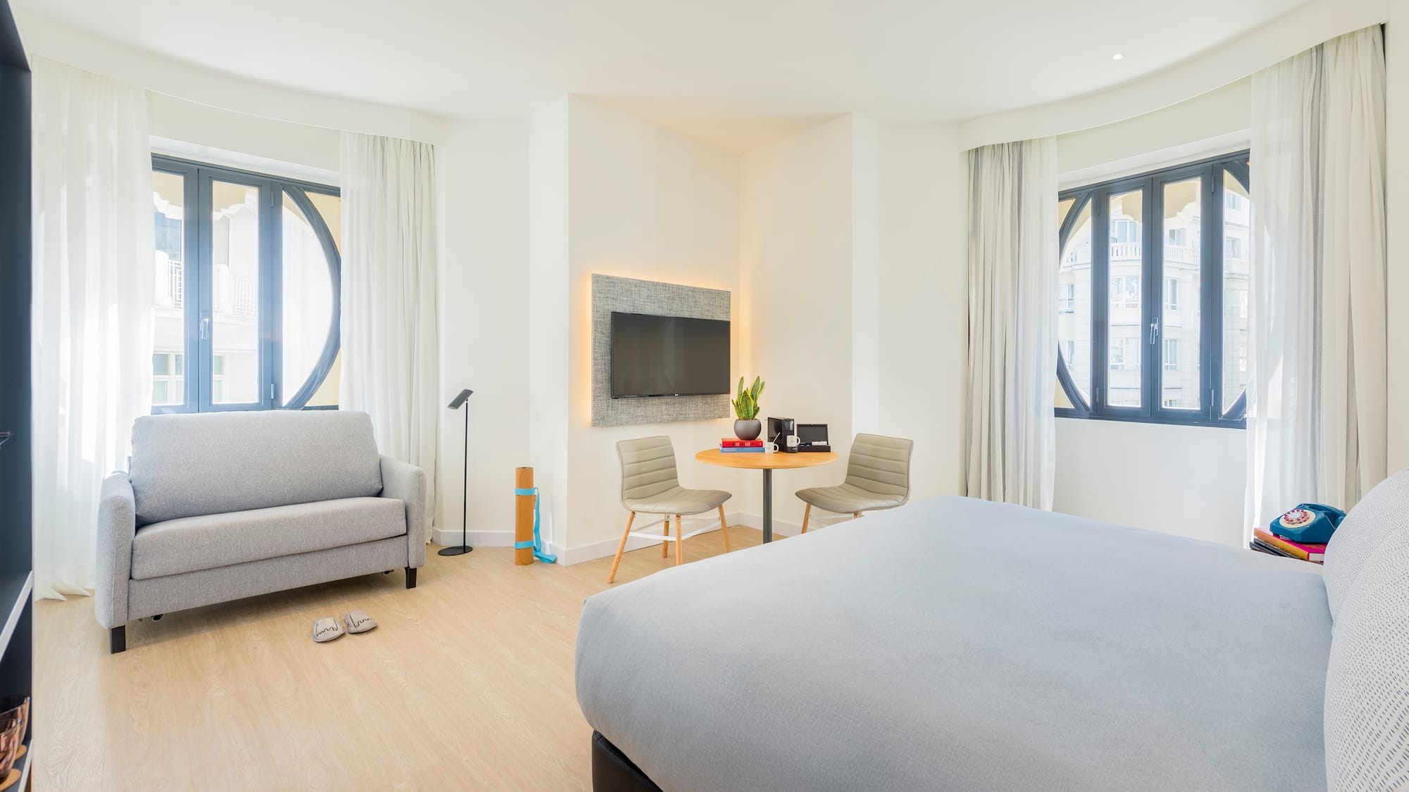 a bedroom with a bed and a tv