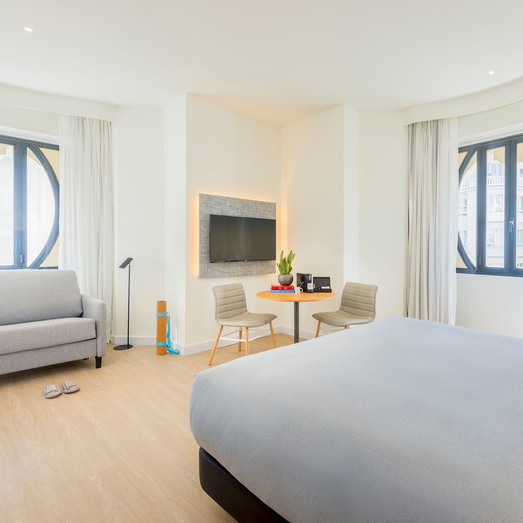 a bedroom with a bed and a tv