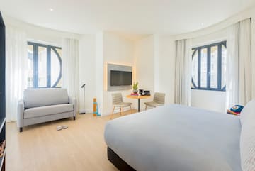 a bedroom with a bed and a tv