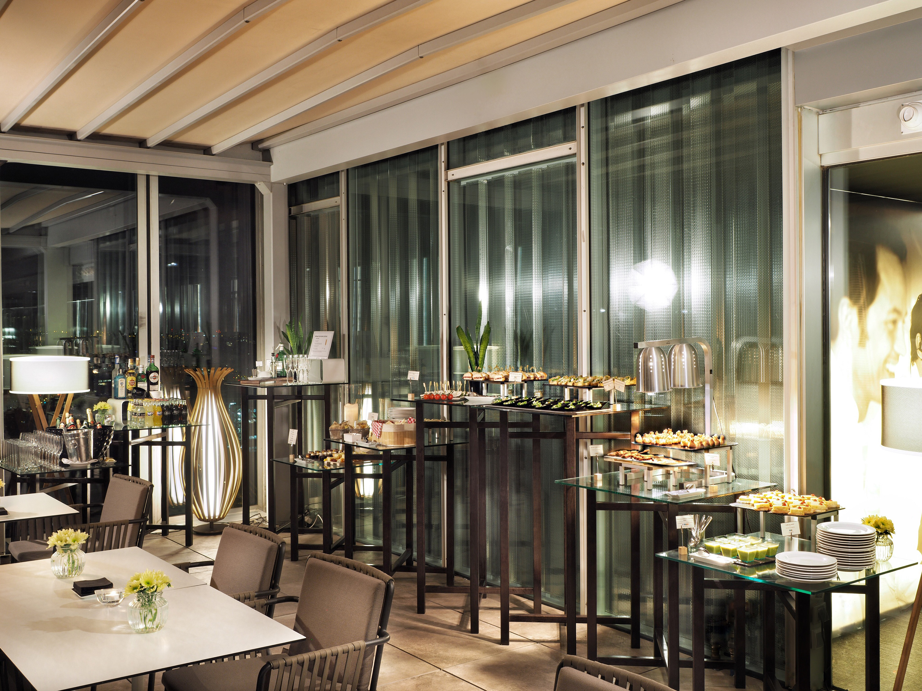 Elegant event buffet with appetizers, desserts, and dining areas.