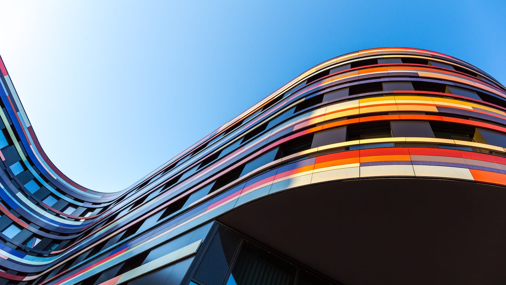 a multi-story building with a curved corner