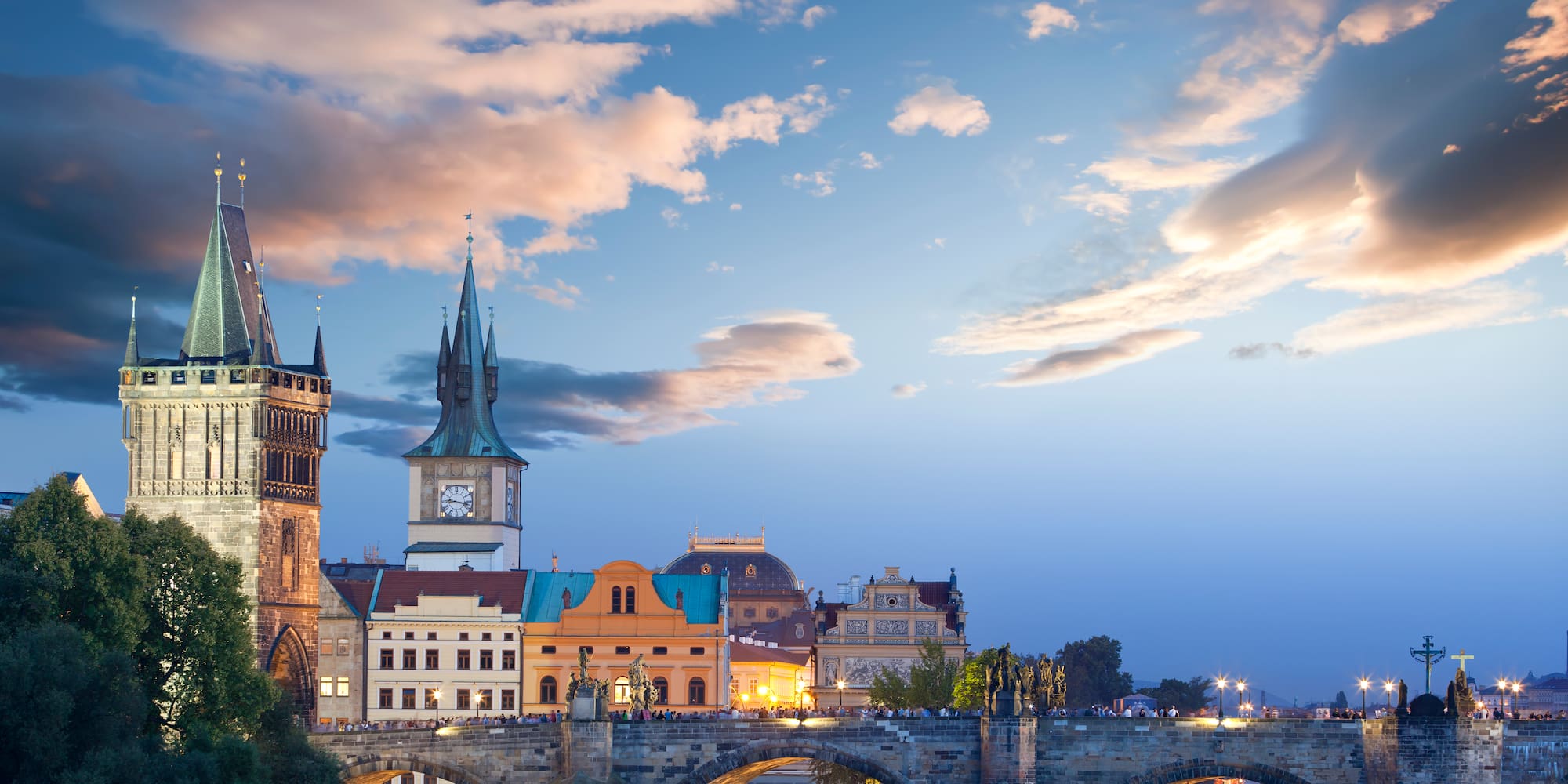 a bridge over water with buildings and trees
