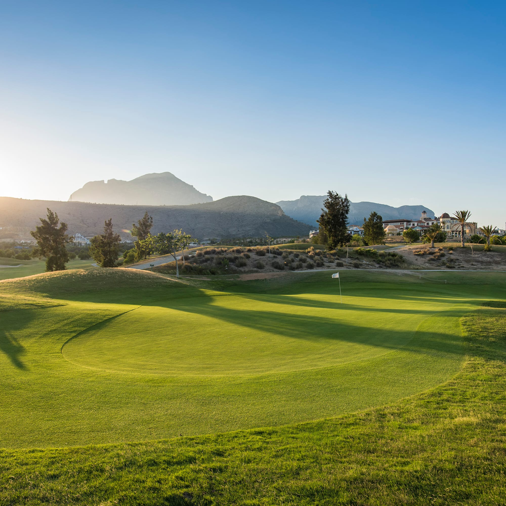 a golf course with a flag on the ground