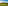 Sunset over green golf course with two golfers, mountains, and distant resort.