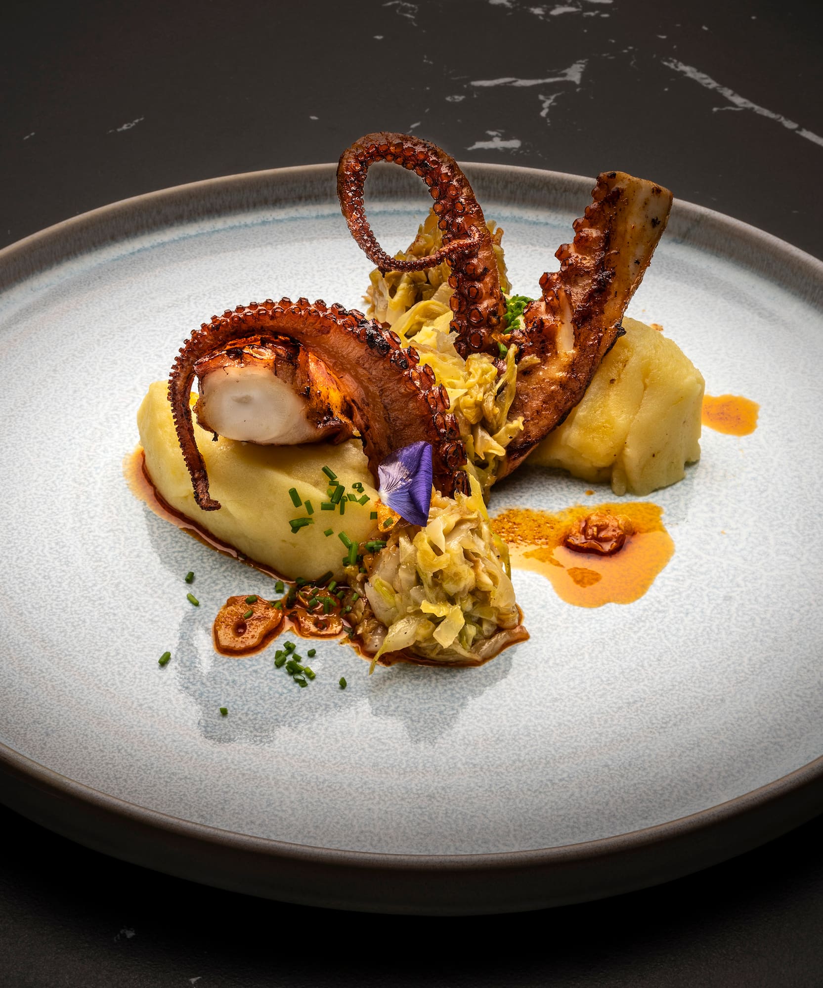 a plate of food on a black surface