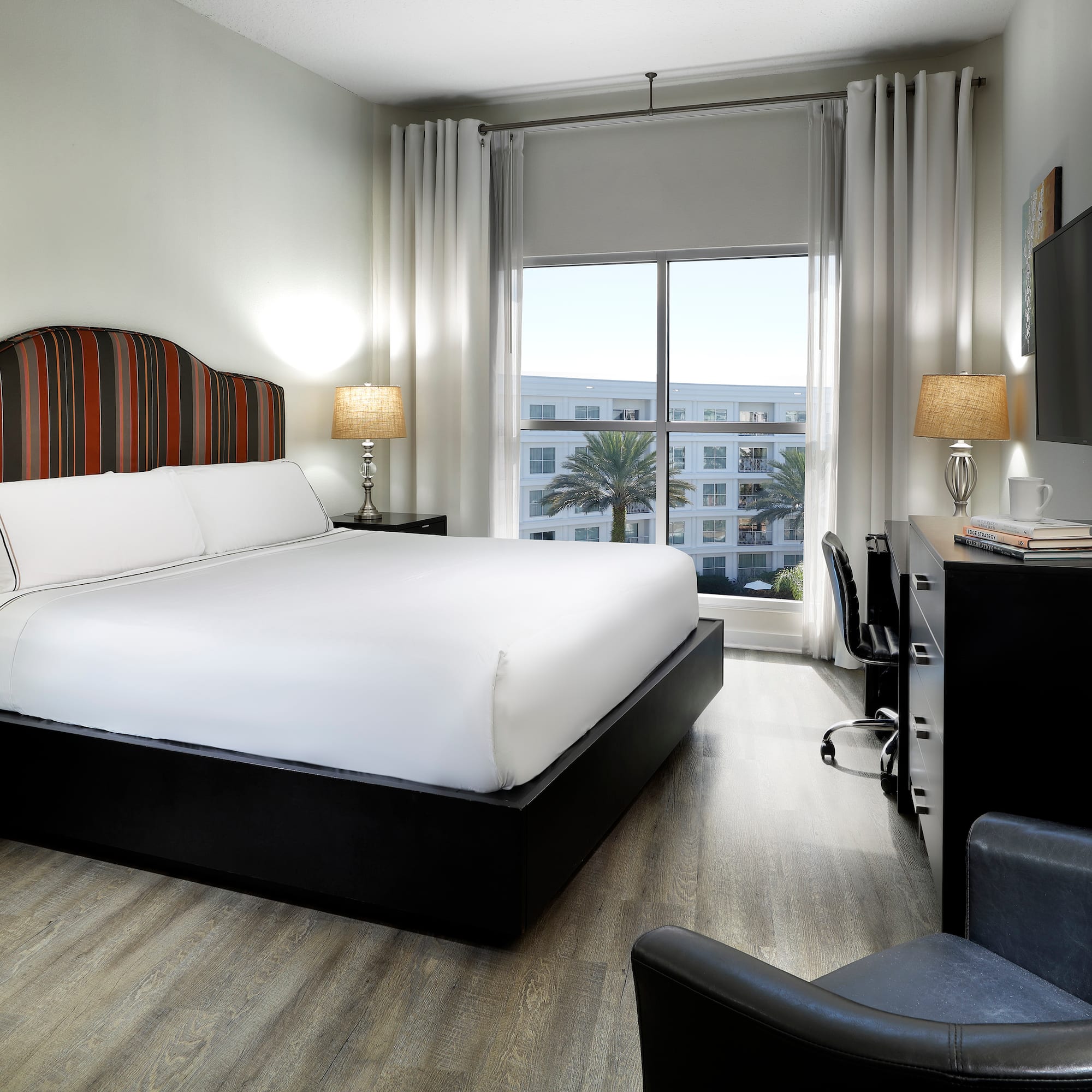 a bedroom with a bed and a tv