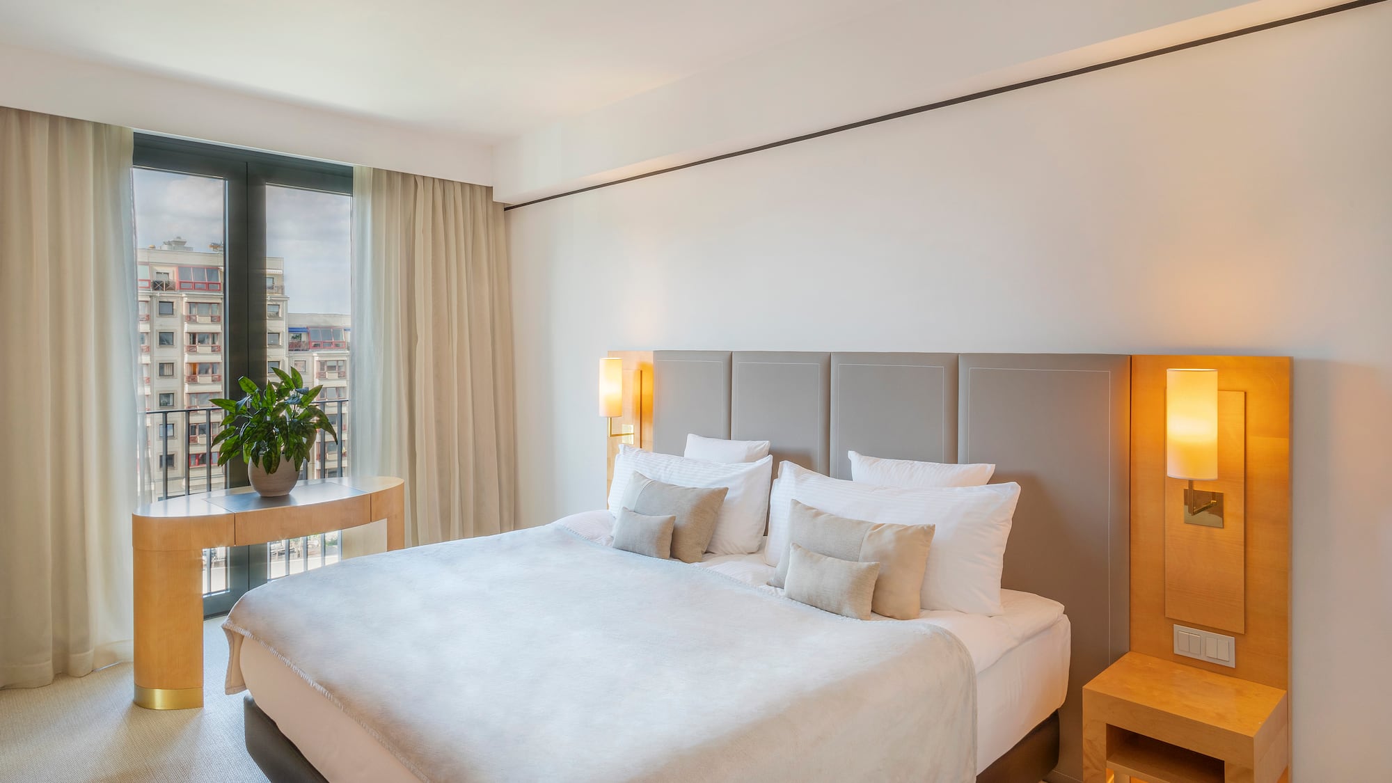 a bed with a lamp and a table