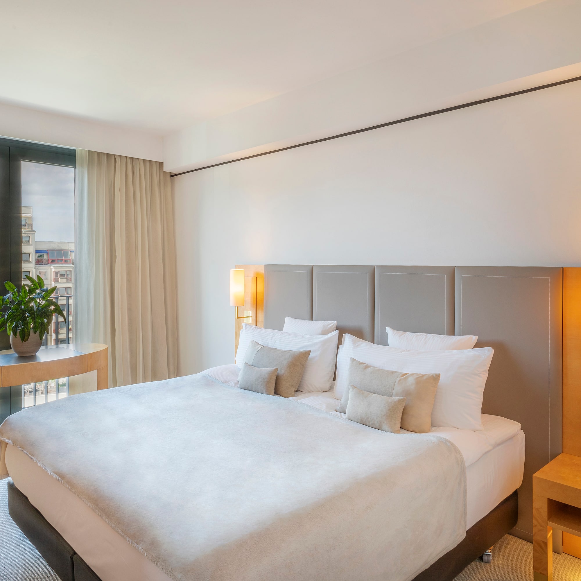 a bed with a lamp and a table