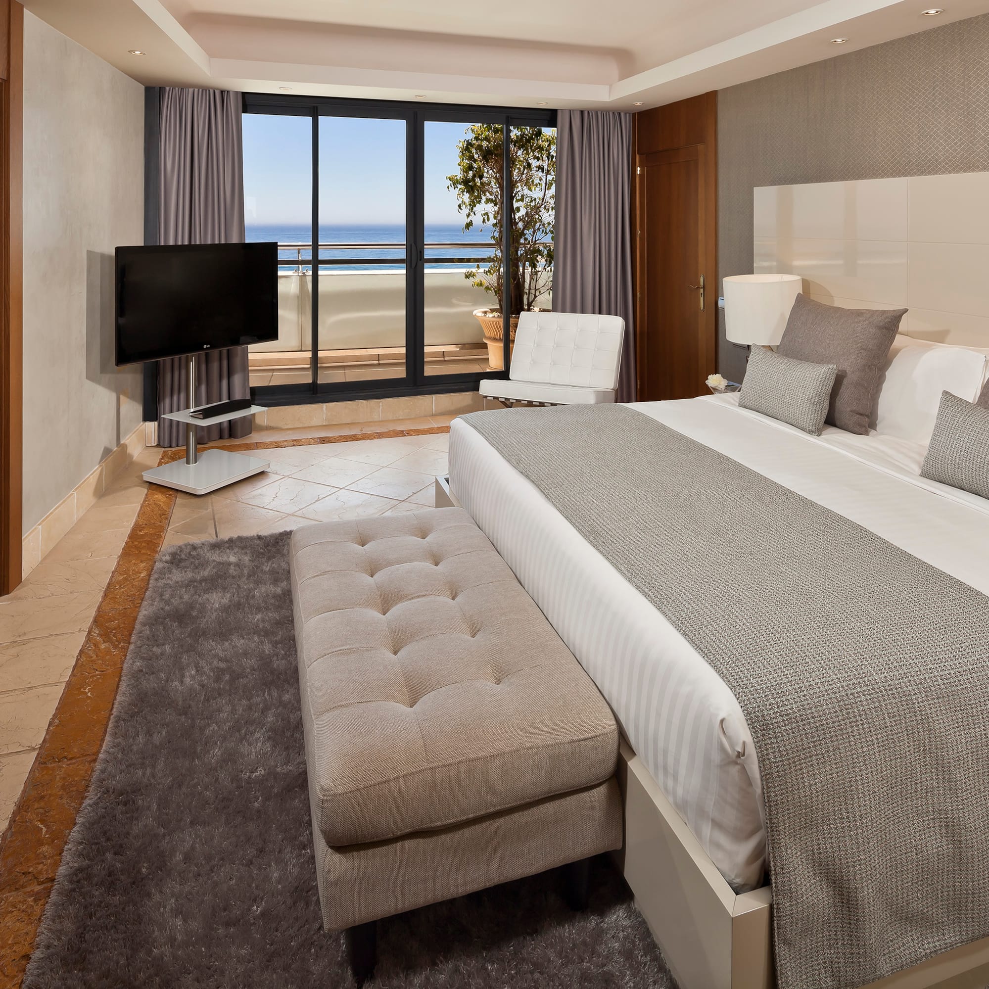 a bedroom with a large bed and a television