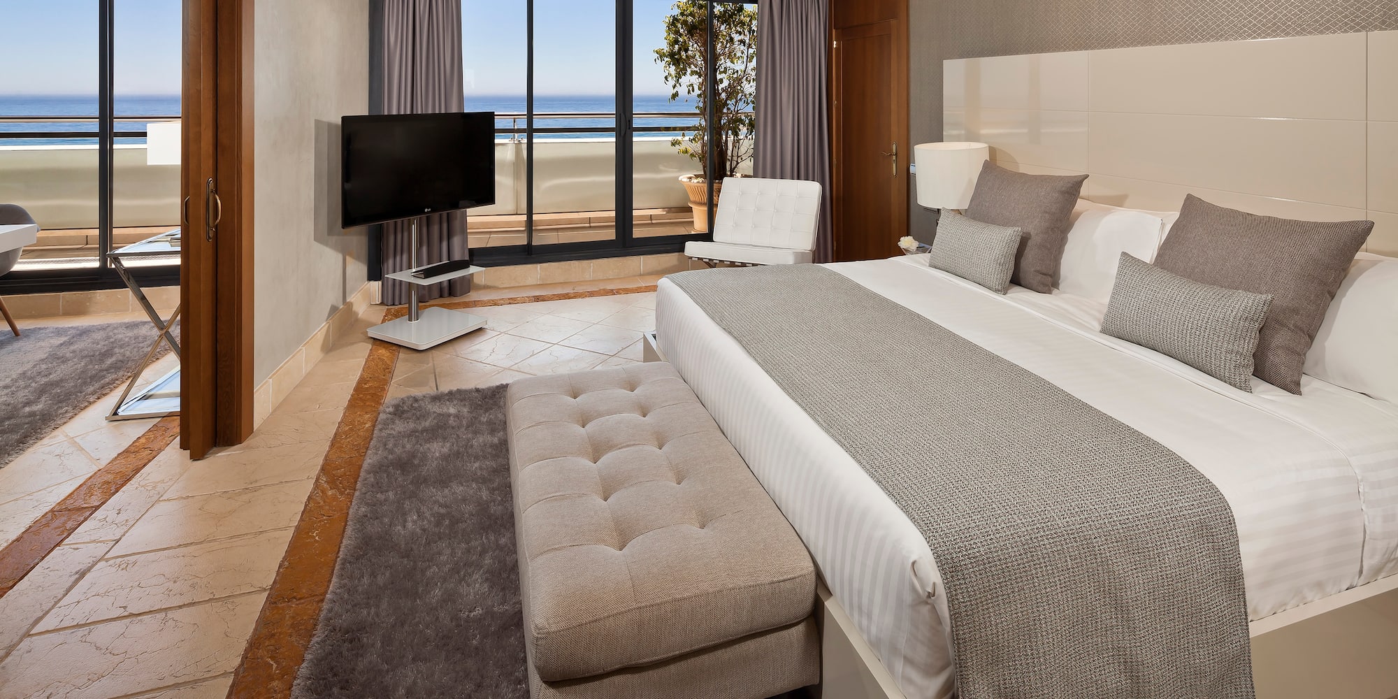 a bedroom with a large bed and a television