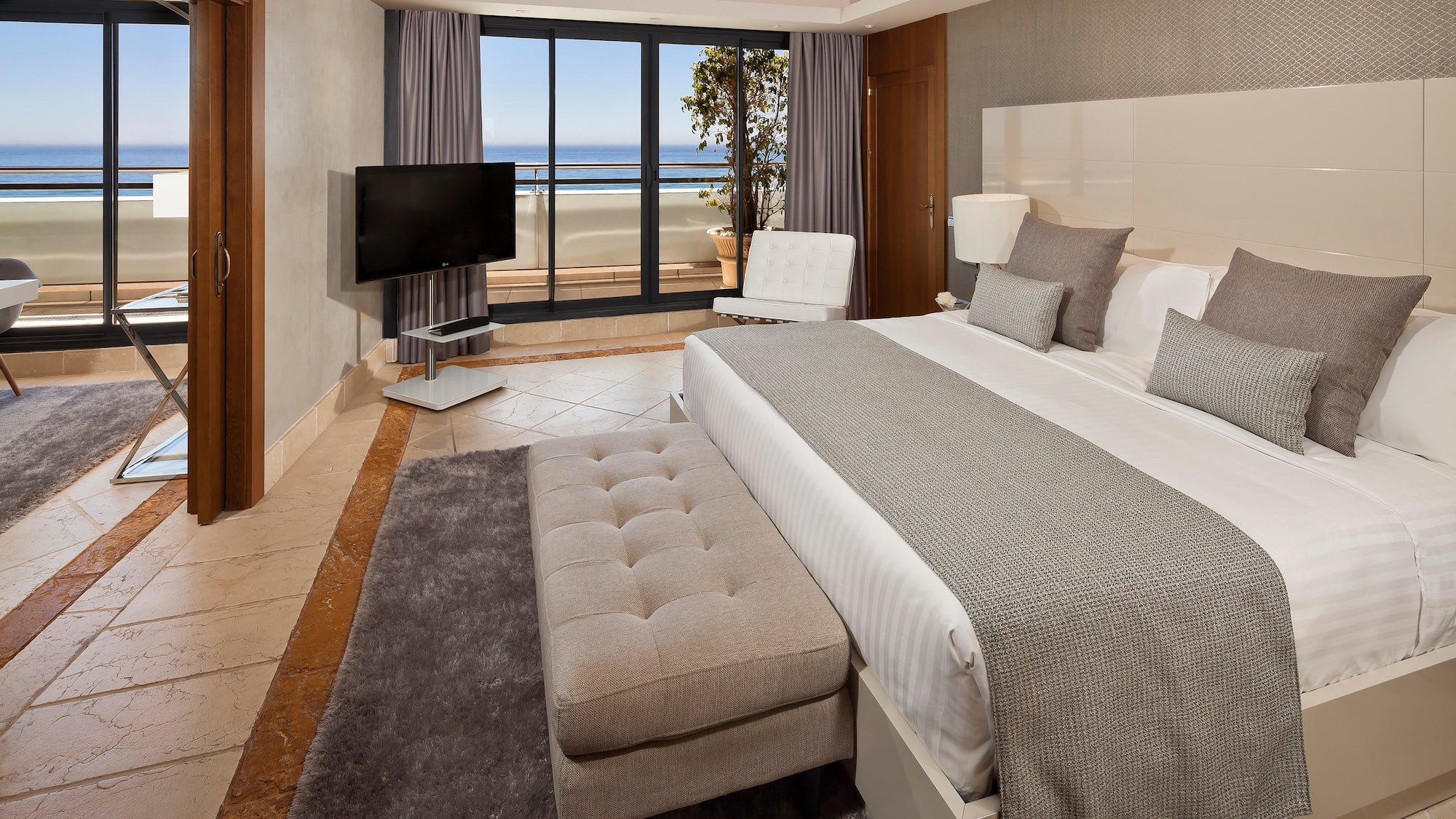 a bedroom with a large bed and a television