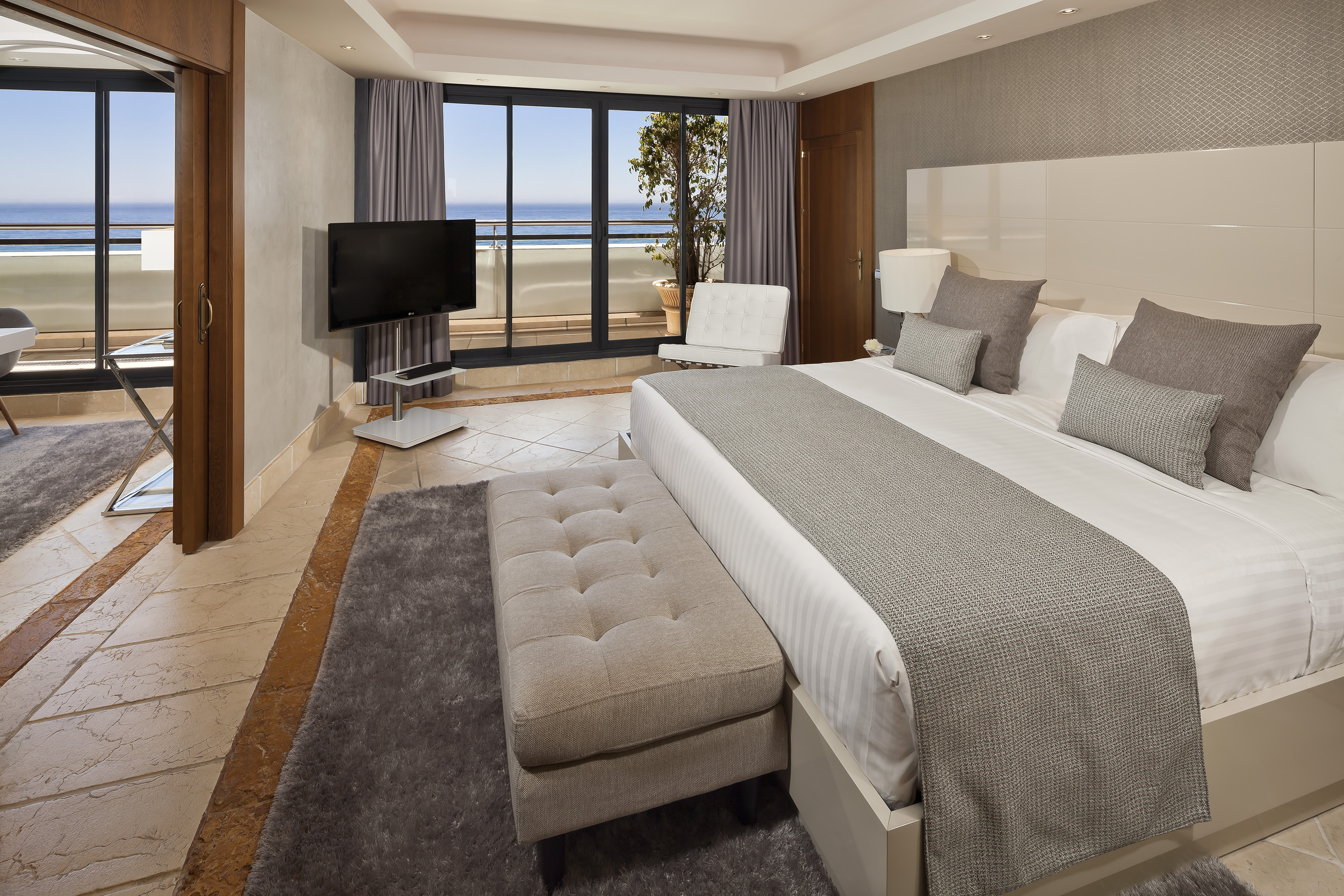 a bedroom with a large bed and a television