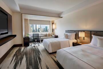 a hotel room with two beds and a desk