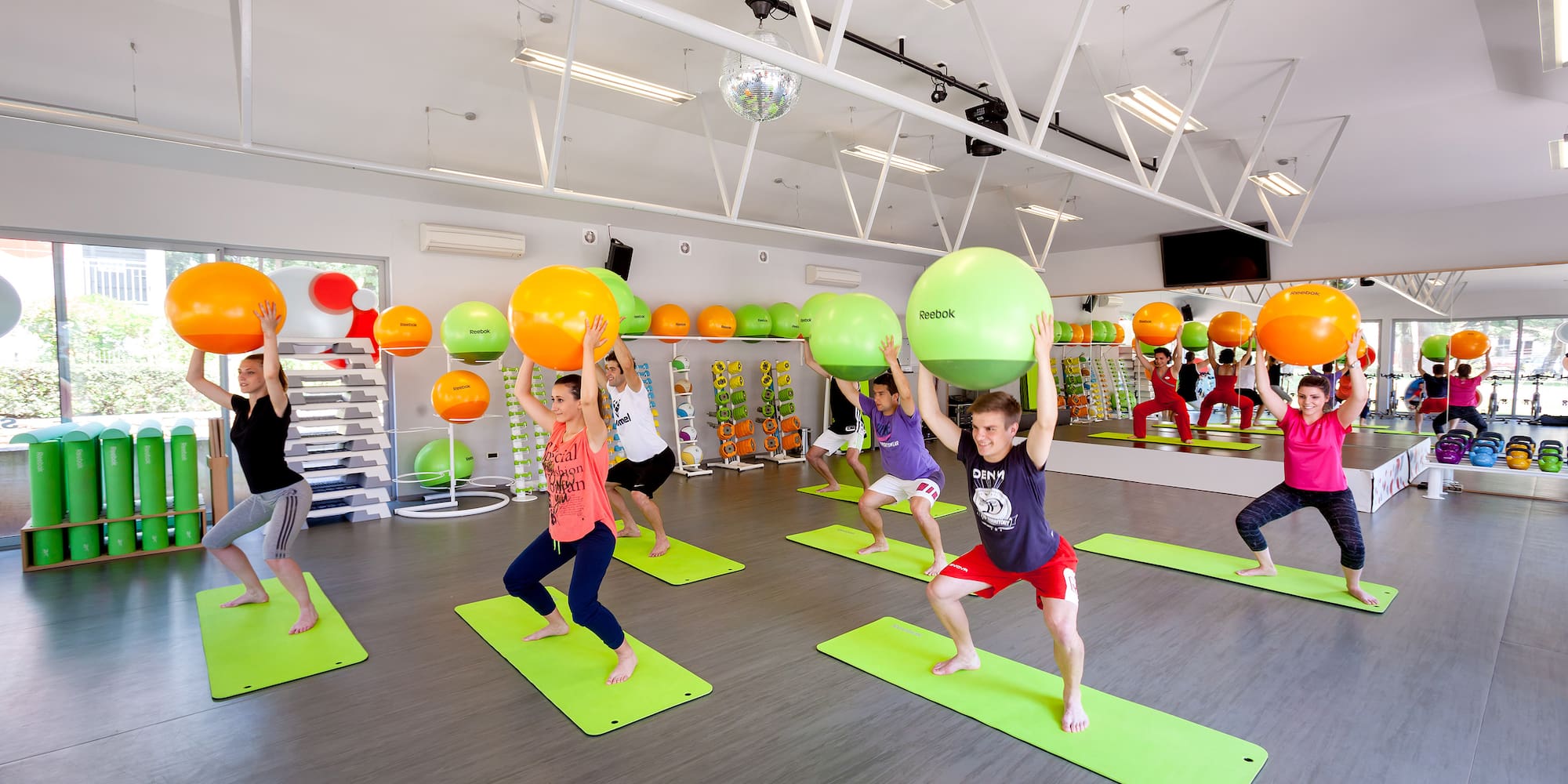 a group of people in a gym with exercise balls