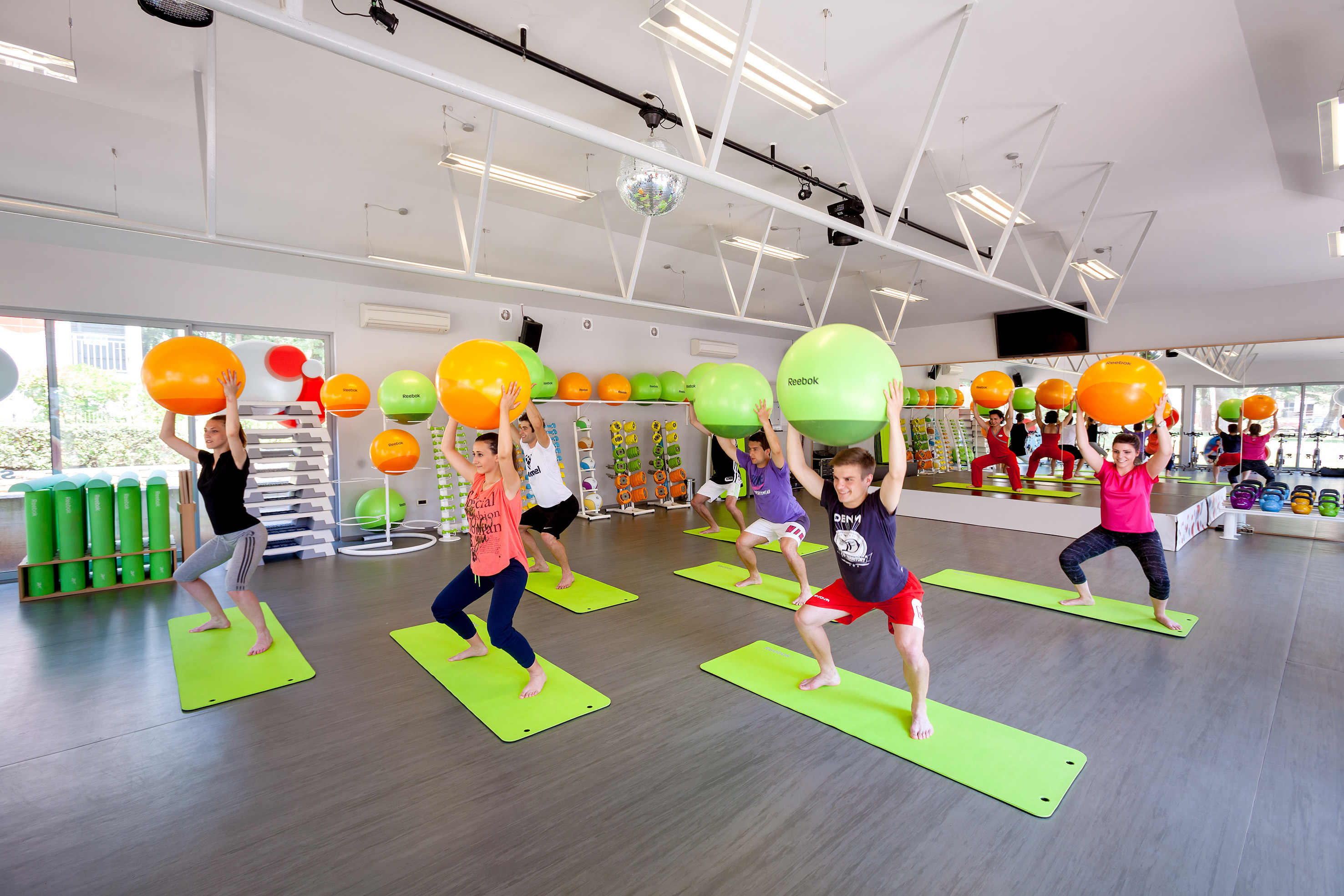 a group of people in a gym with exercise balls