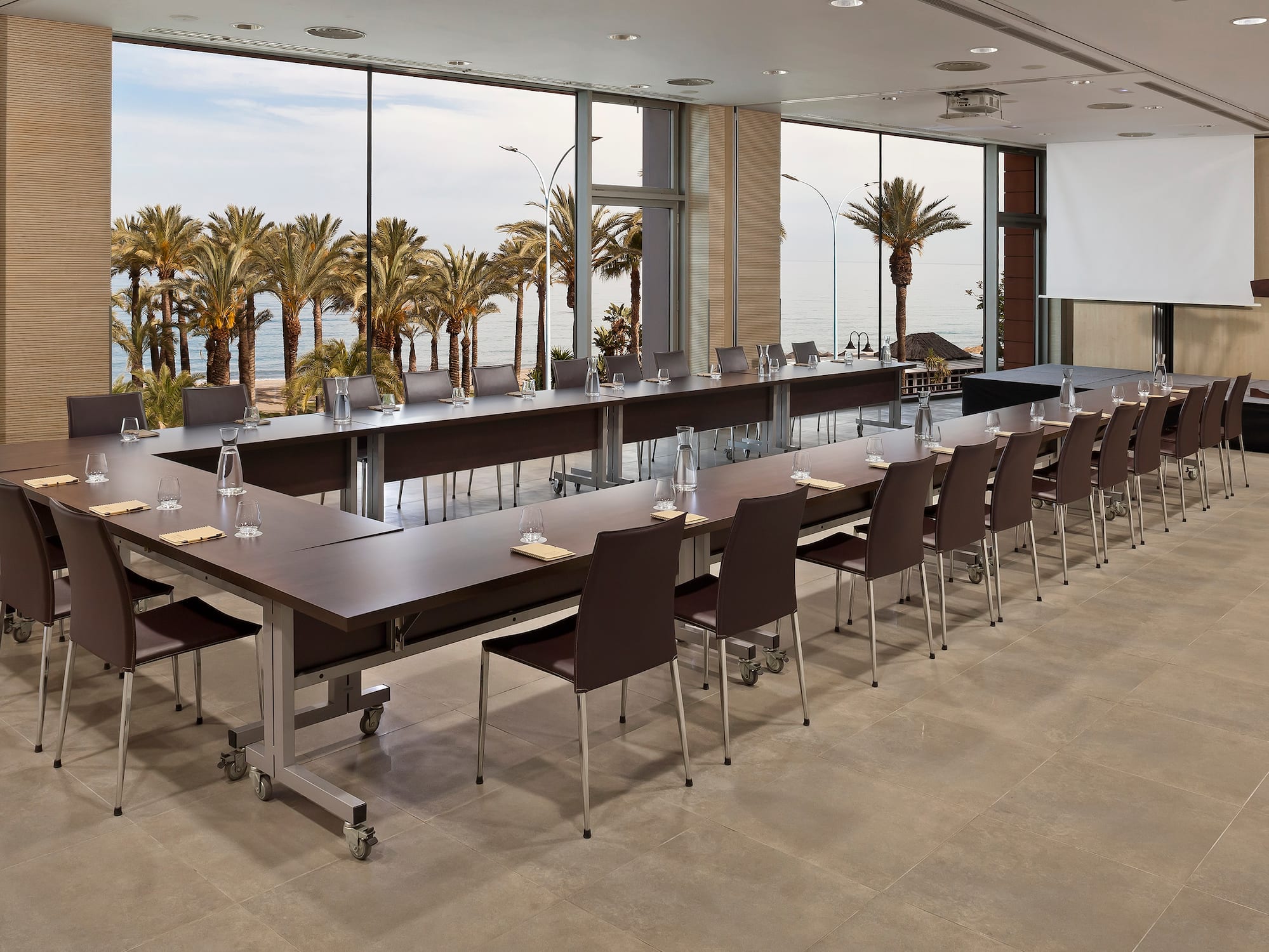 a large conference room with long tables and chairs