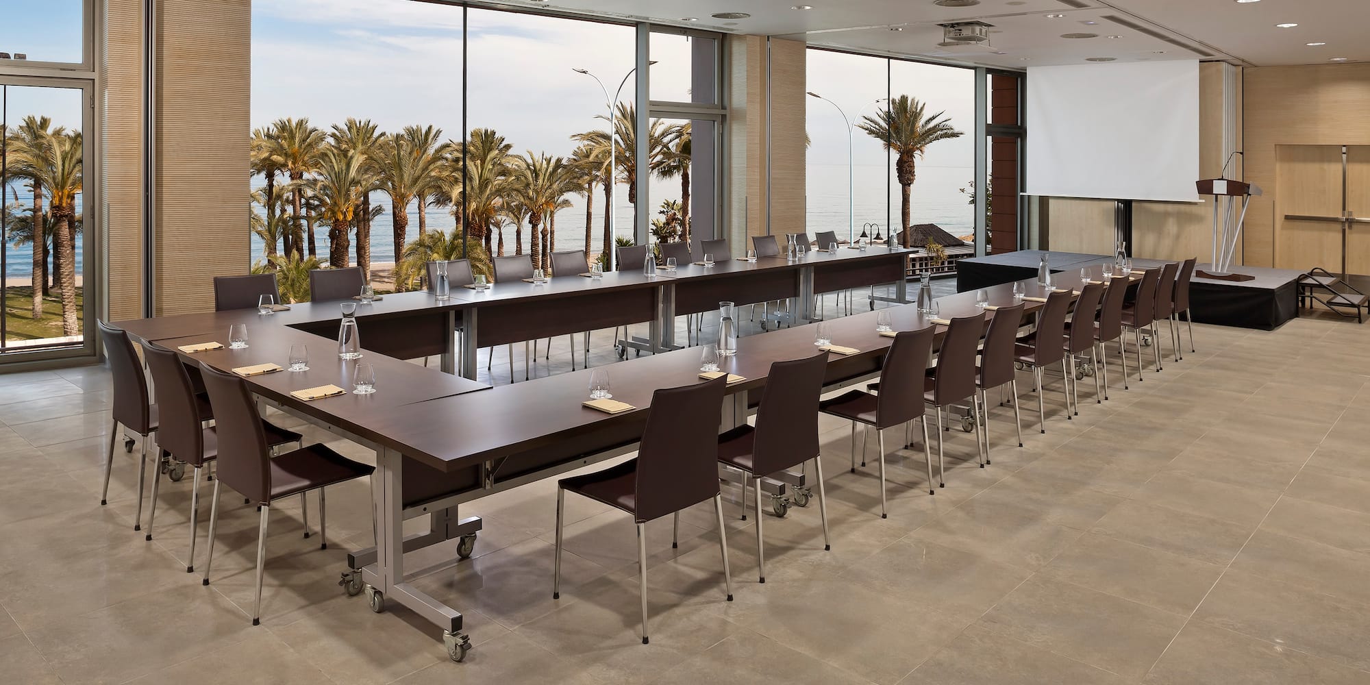 a large conference room with long tables and chairs