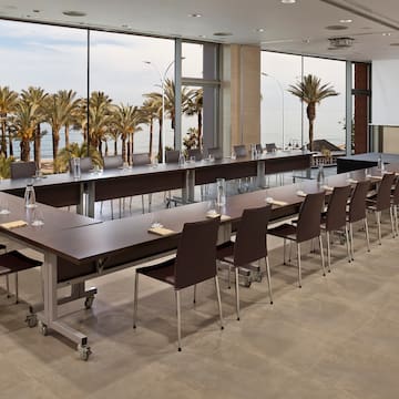 a large conference room with long tables and chairs