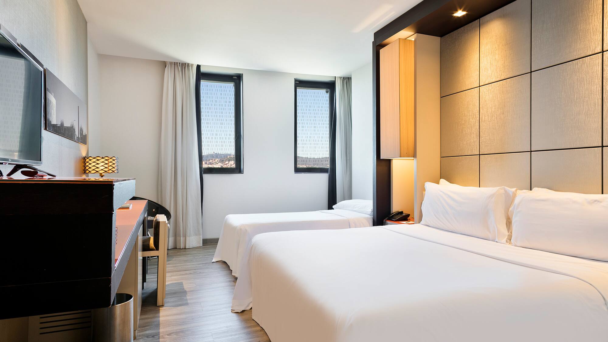 a room with two beds and a piano