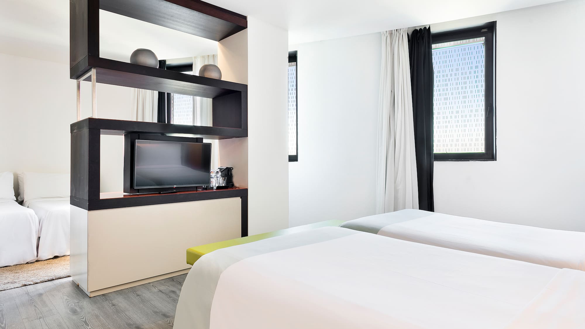 a room with two beds and a tv