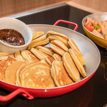 pancakes in a pan with a sauce in it
